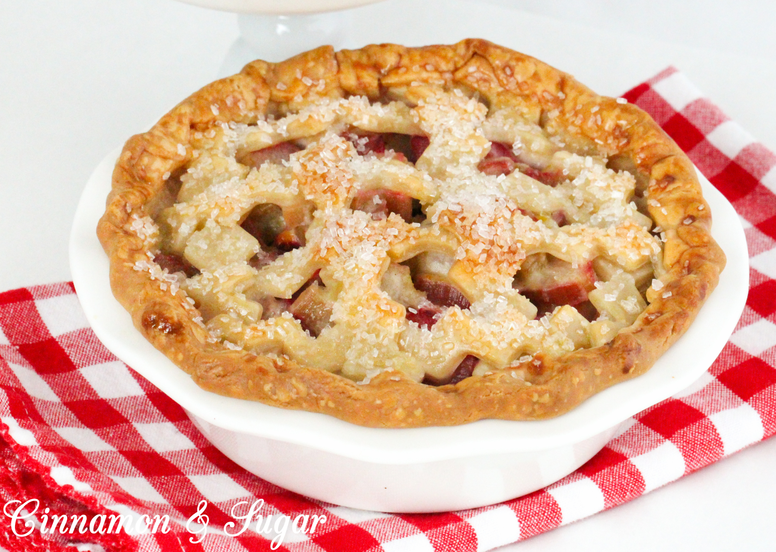 Juicy and sweet/tart, the pretty and delicious pink rhubarb filling and flaky crust make these mini rhubarb pies a delicious ending to any meal. Recipe shared with permission granted by Tracy Gardner, author of BEHIND THE FRAME.