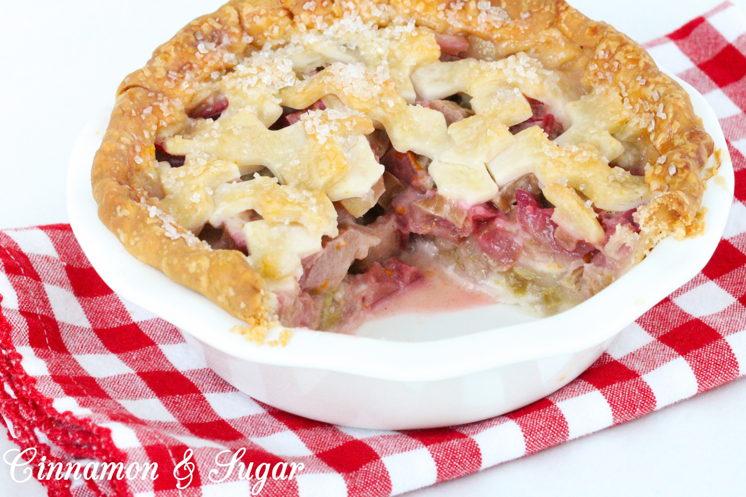 Juicy and sweet/tart, the pretty and delicious pink rhubarb filling and flaky crust make these mini rhubarb pies a delicious ending to any meal. Recipe shared with permission granted by Tracy Gardner, author of BEHIND THE FRAME.