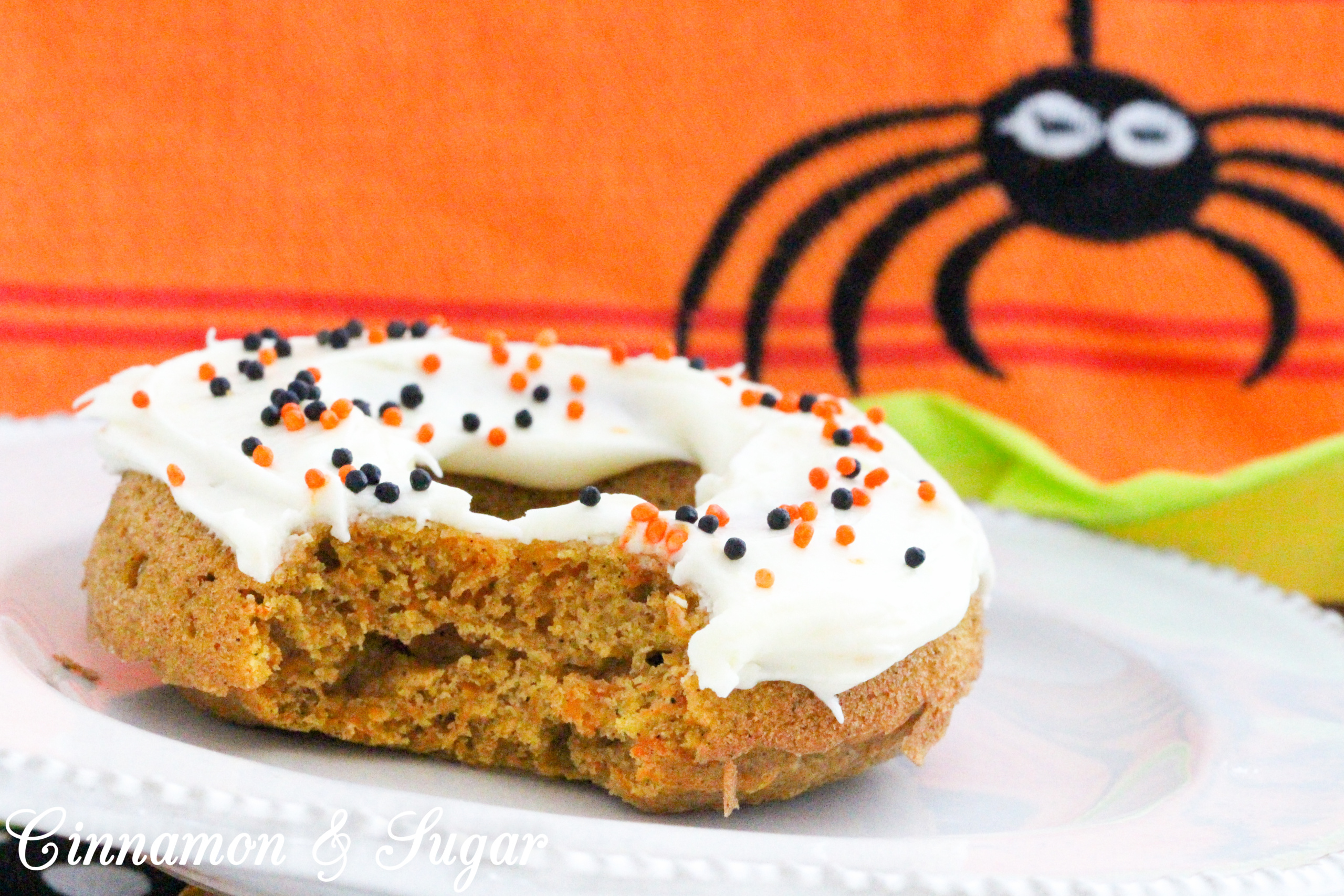 Scare-It Cake Donuts are a riff on Carrot Cake! Filled with warm, autumn spices and a generous portion of grated carrots to keep them extra moist, these donuts are a treat for all gouls and goblins! Recipe shared with permission granted by Ginger Bolton, author of BOSTON SCREAM MURDER. 