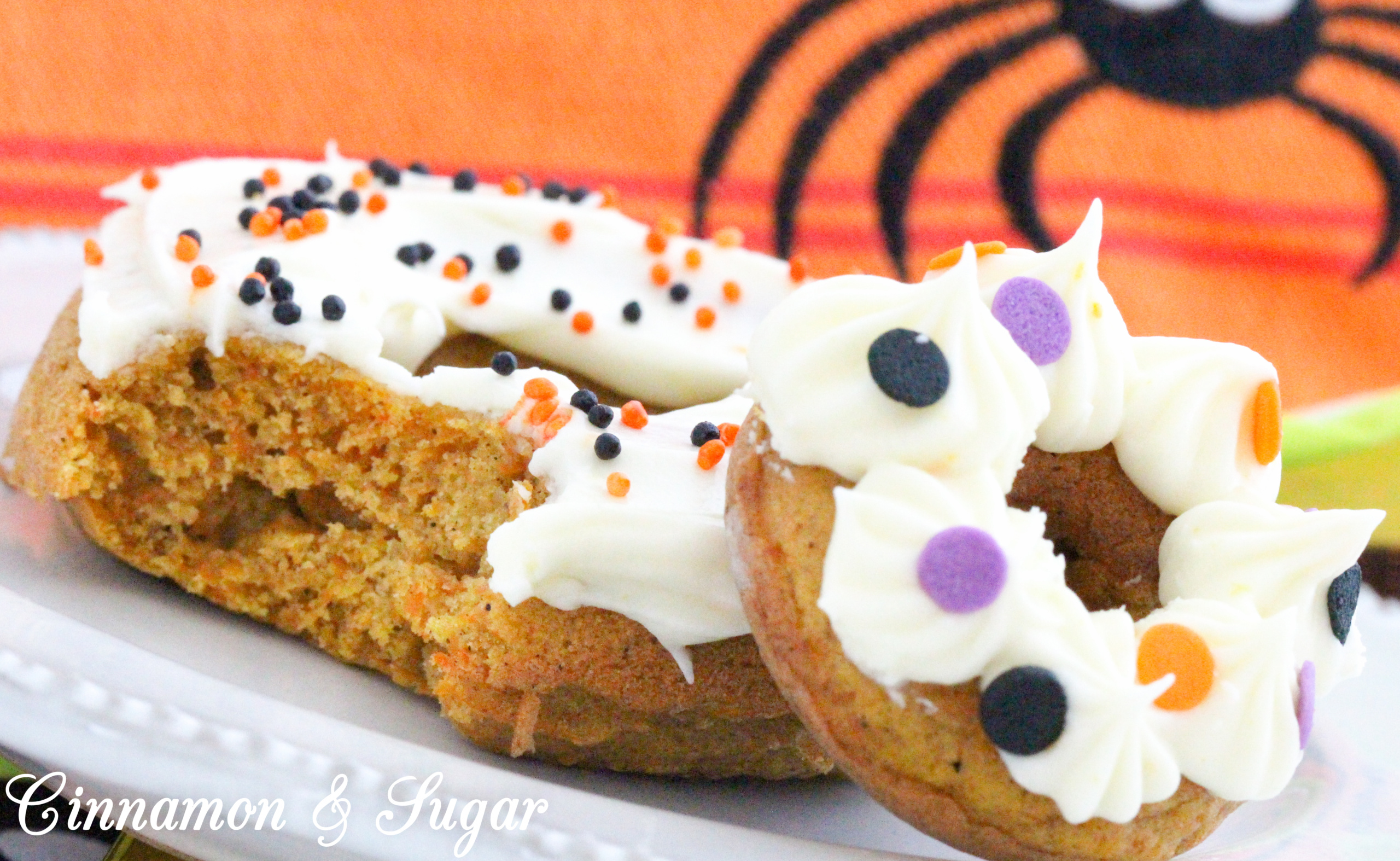 Scare-It Cake Donuts are a riff on Carrot Cake! Filled with warm, autumn spices and a generous portion of grated carrots to keep them extra moist, these donuts are a treat for all gouls and goblins! Recipe shared with permission granted by Ginger Bolton, author of BOSTON SCREAM MURDER. 