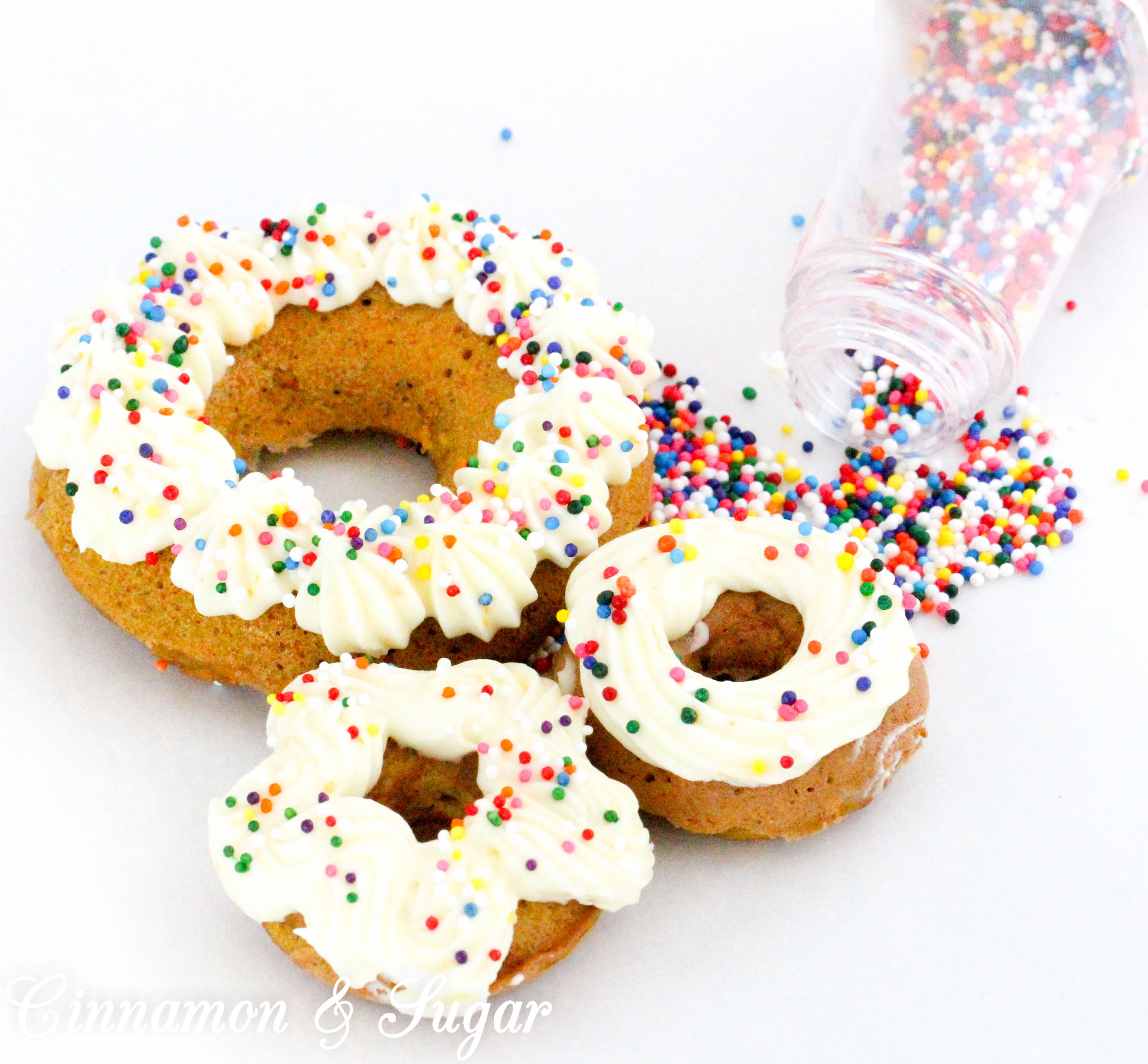 Scare-It Cake Donuts are a riff on Carrot Cake! Filled with warm, autumn spices and a generous portion of grated carrots to keep them extra moist, these donuts are a treat for all gouls and goblins! Recipe shared with permission granted by Ginger Bolton, author of BOSTON SCREAM MURDER. 