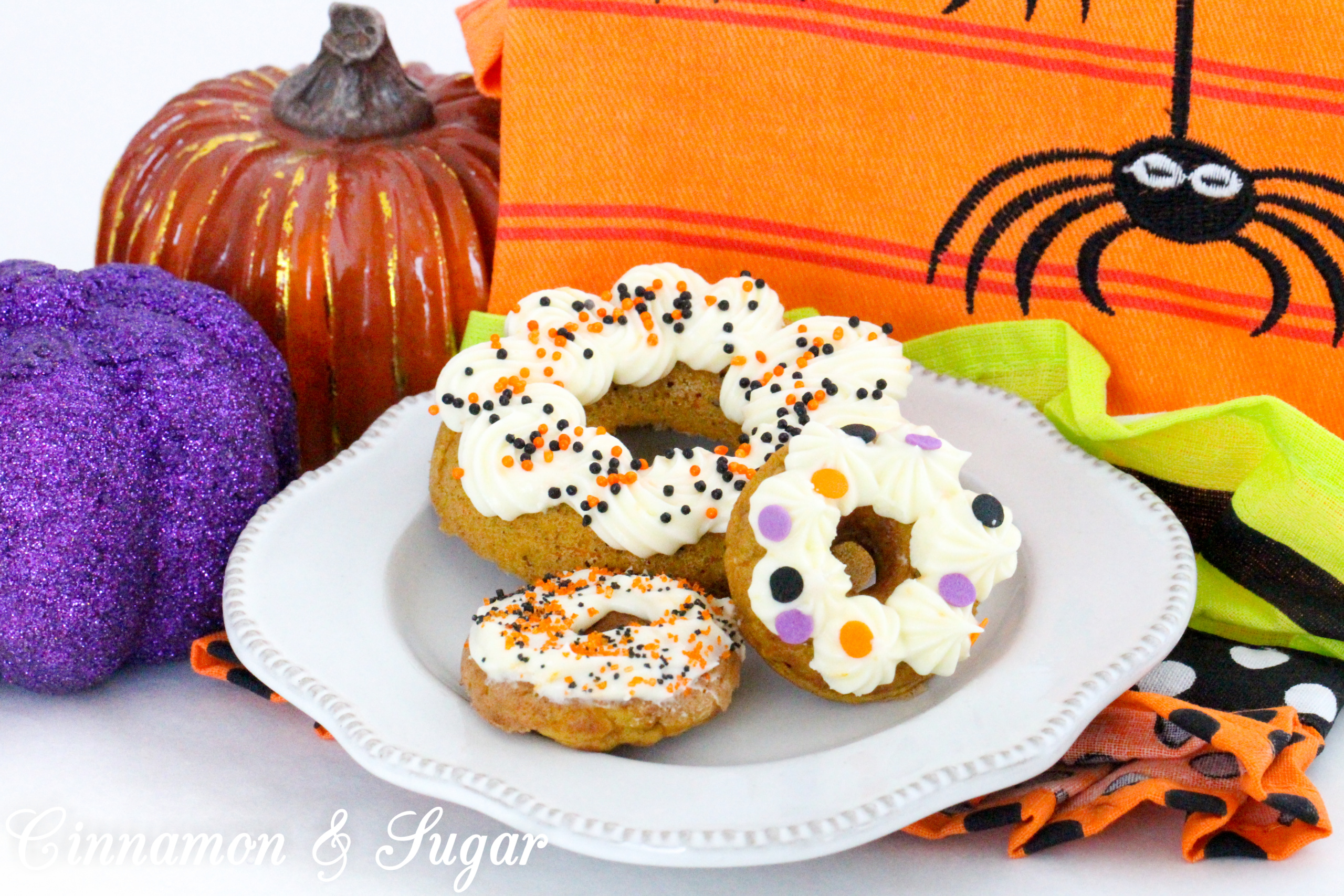 Scare-It Cake Donuts are a riff on Carrot Cake! Filled with warm, autumn spices and a generous portion of grated carrots to keep them extra moist, these donuts are a treat for all gouls and goblins! Recipe shared with permission granted by Ginger Bolton, author of BOSTON SCREAM MURDER. 