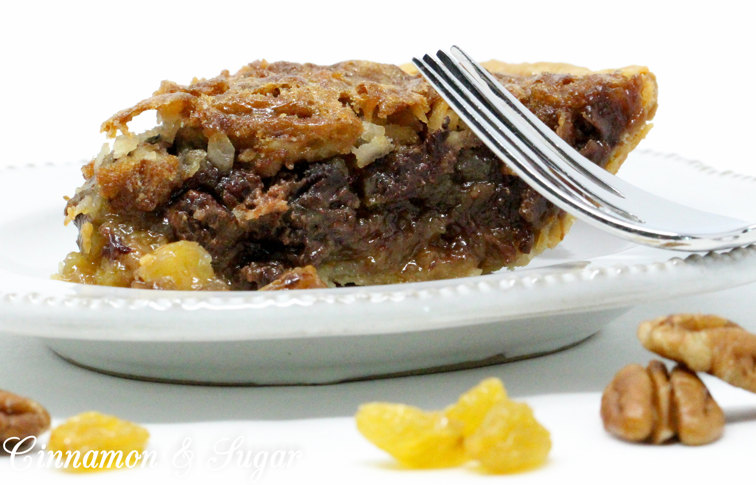 With a base similar to pecan pie, the addition of chocolate, raisins, and coconut raises the scrumptious level of Sugar High Pie to the stratosphere! Recipe shared with permission granted by Ellen Byron, author of MURDER IN THE BAYOU BONEYARD.