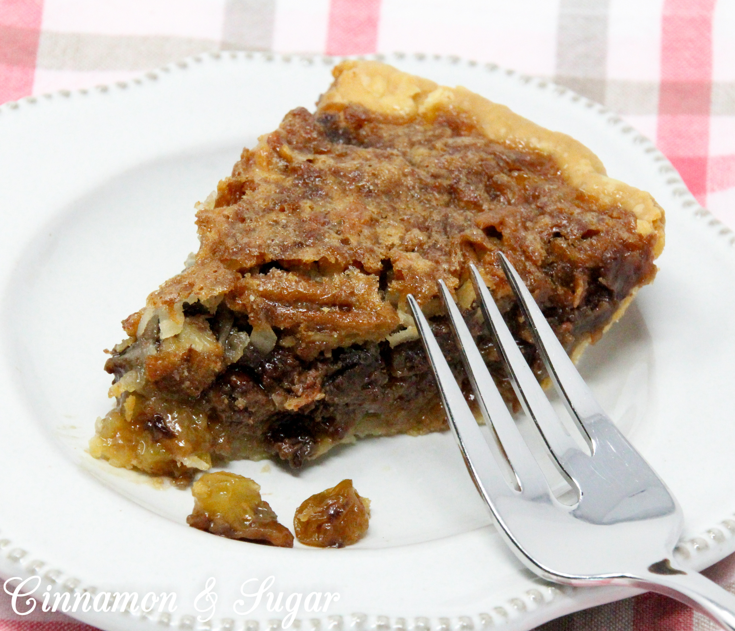 With a base similar to pecan pie, the addition of chocolate, raisins, and coconut raises the scrumptious level of Sugar High Pie to the stratosphere! Recipe shared with permission granted by Ellen Byron, author of MURDER IN THE BAYOU BONEYARD.