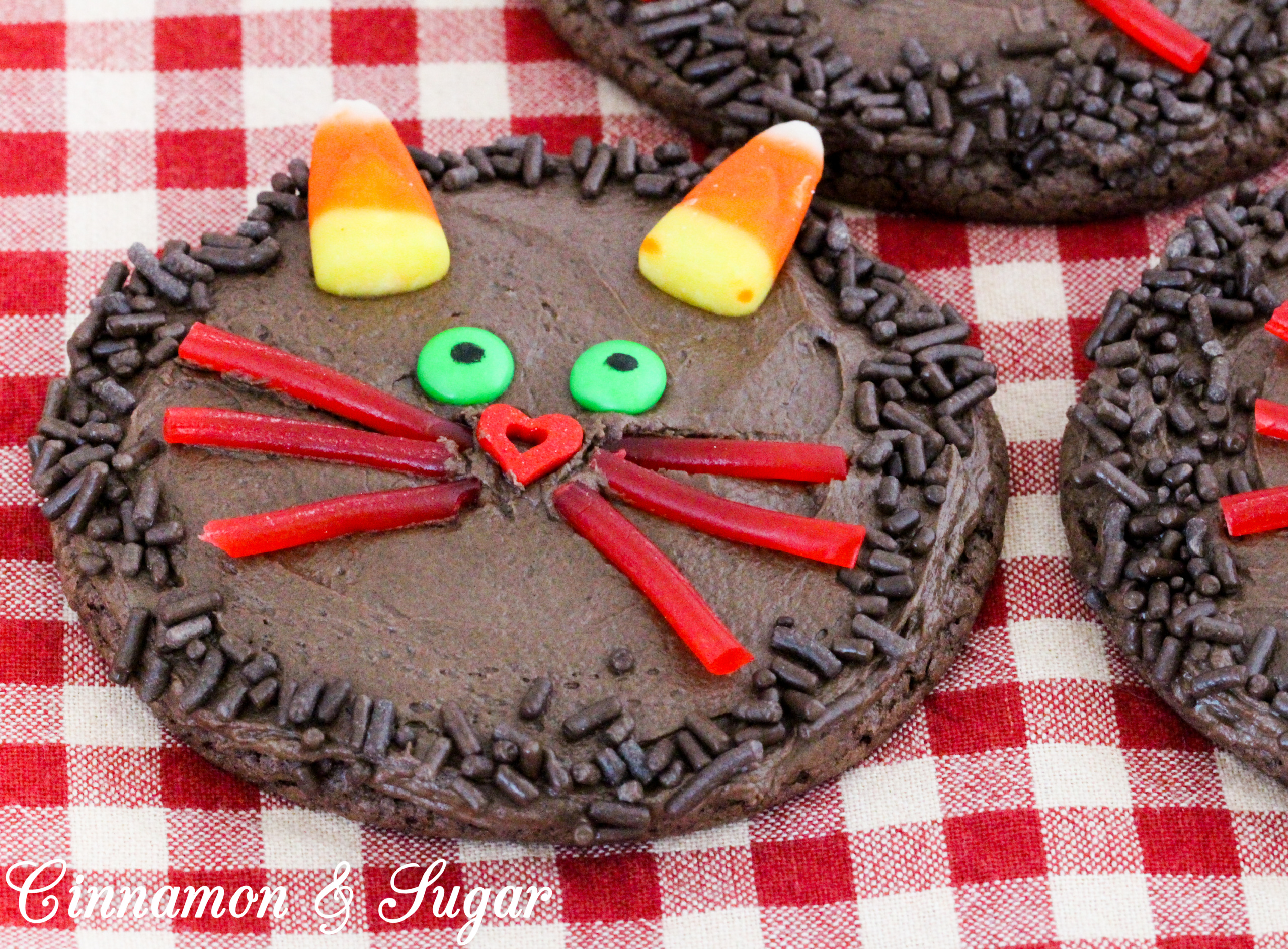 Halloween Black Cat Chocolate Cookies start with a base cookie using only 3 simple ingredients and then your ghosts and ghouls can use fun candies to create a yummy Halloween Treat! Recipe from CAKE POPPED OFF by Kim Davis.