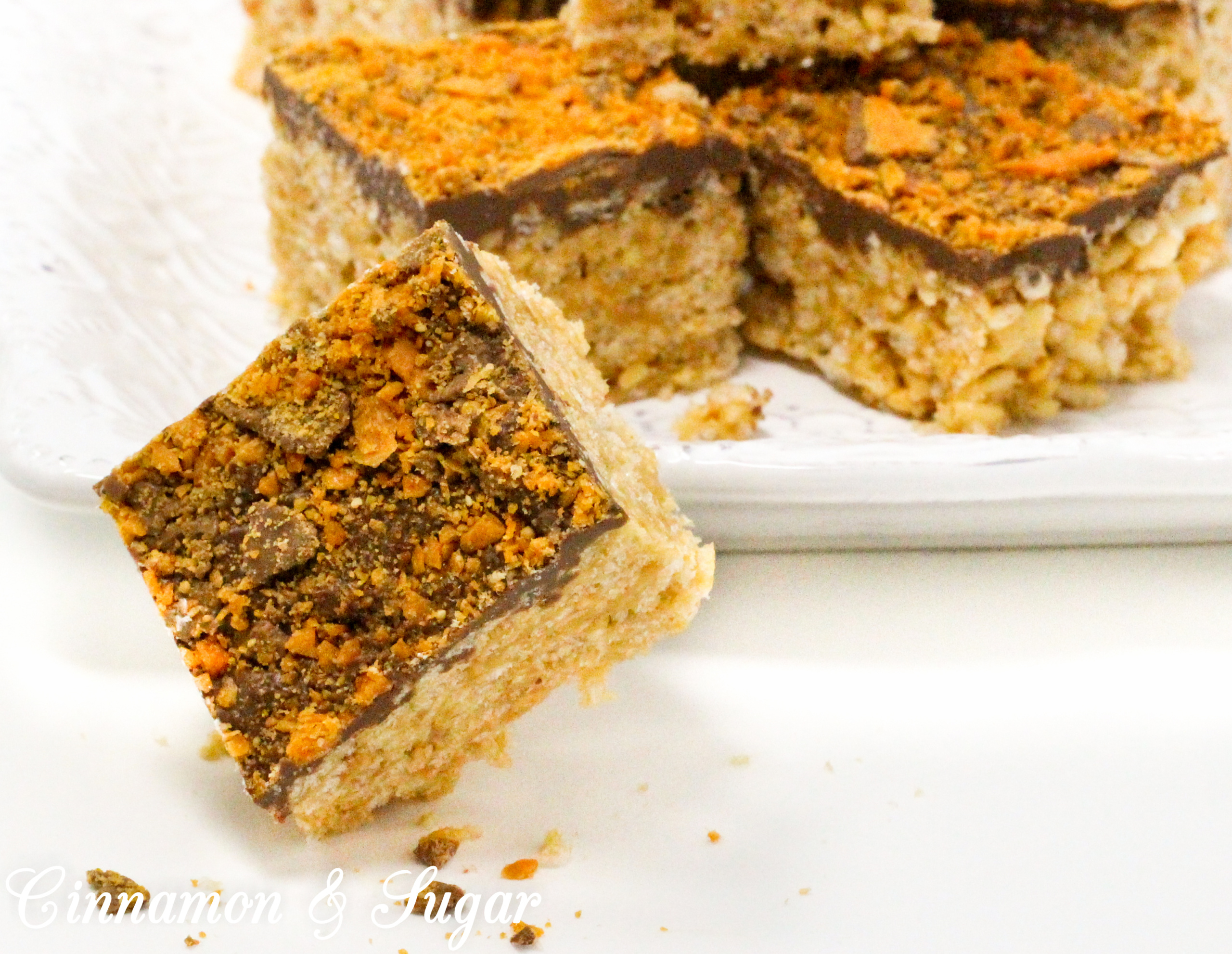 A delicious riff on Rice Krispie Treats, Butterfinger Krispie Bars combines the flavors of the iconic candy bar: chocolate, butterscotch, and peanut butter! Recipe created by Cinnamon & Sugar for Deborah Garner, author of cozy mystery, A FLAIR FOR GOBLINS.