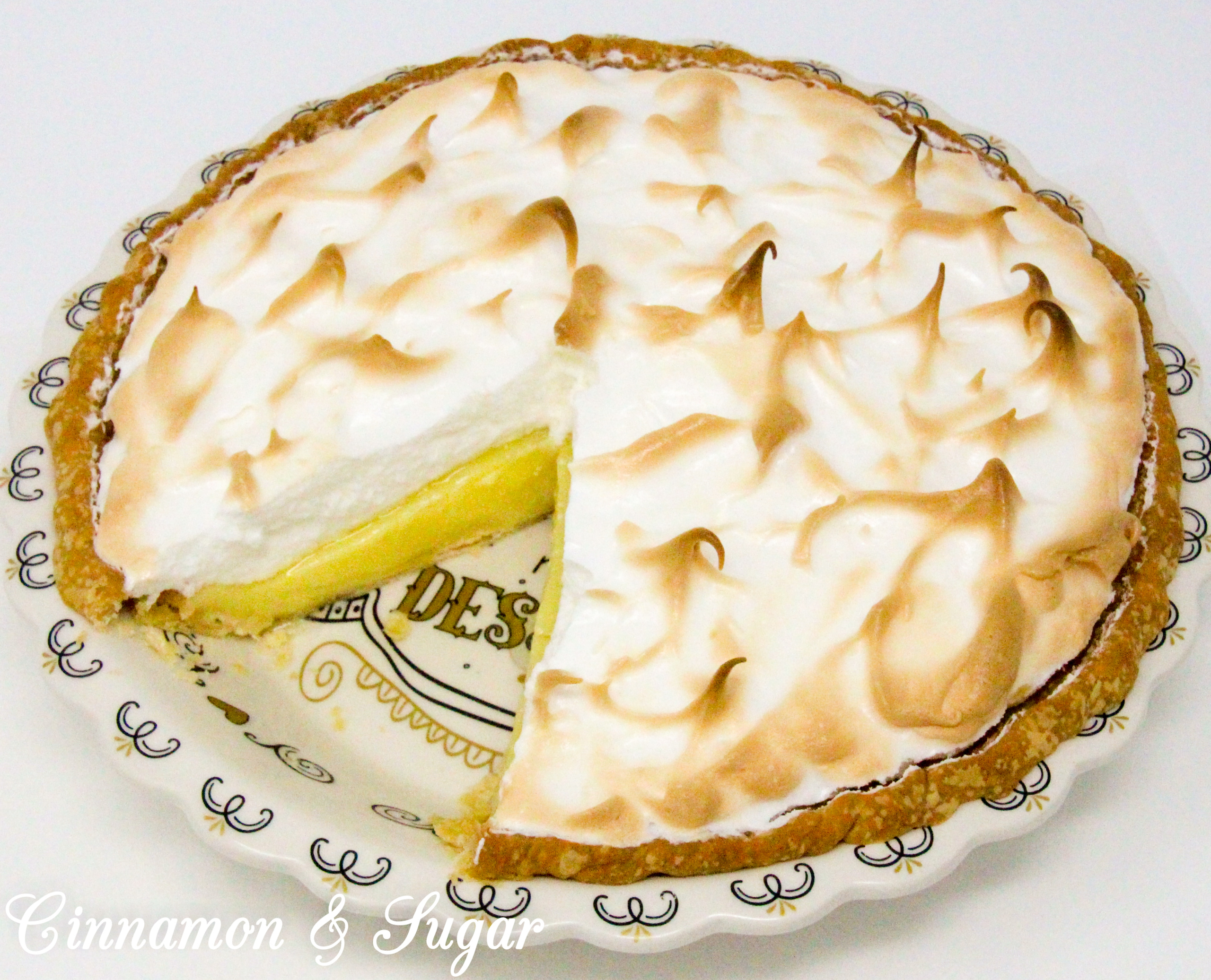 Lemony sweet-tart custard filling piled high with billowing cloud-like meringue, Susan Cutie's Lemon Meringue Pie is a refreshing dessert! Recipe shared with permission granted by Tina Kashian, author of MISTLETOE, MOUSSAKA, AND MURDER.