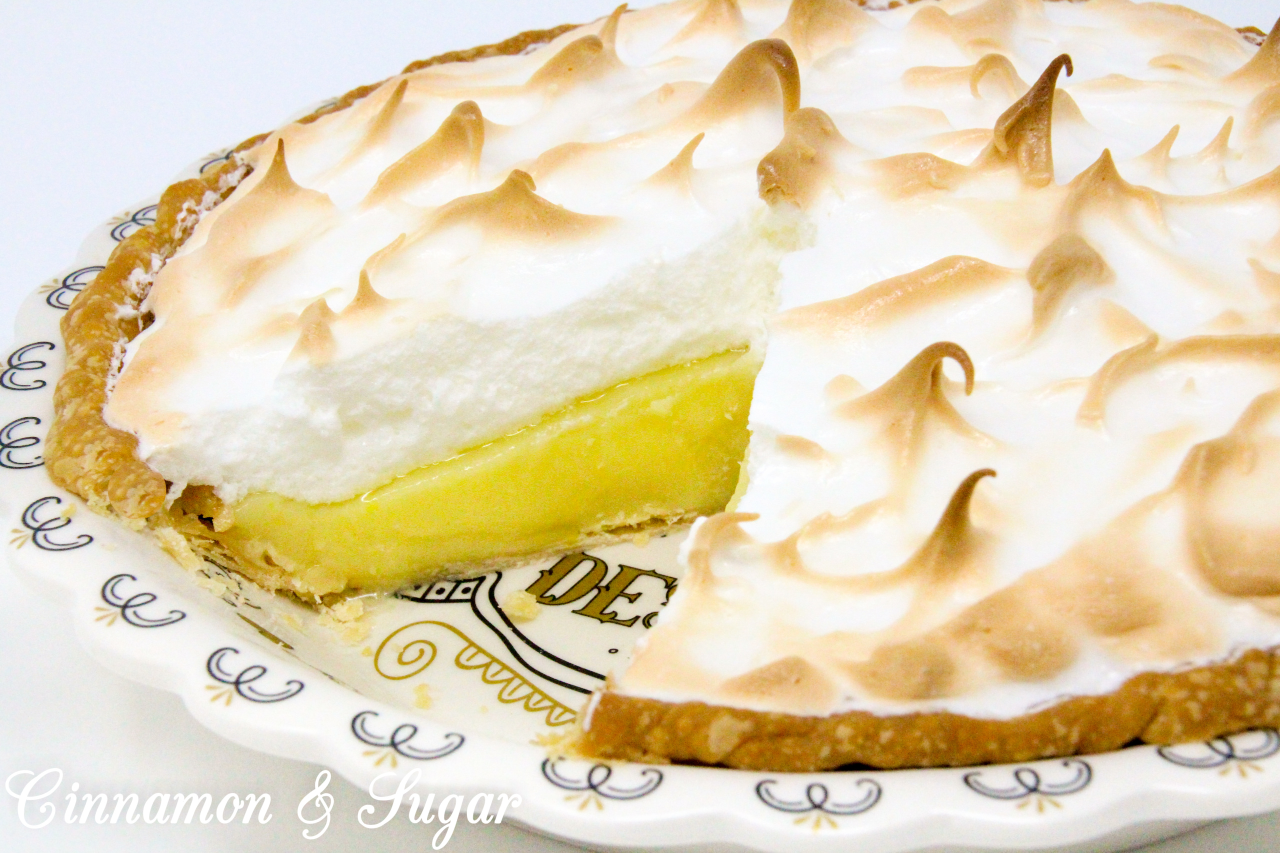 Lemony sweet-tart custard filling piled high with billowing cloud-like meringue, Susan Cutie's Lemon Meringue Pie is a refreshing dessert! Recipe shared with permission granted by Tina Kashian, author of MISTLETOE, MOUSSAKA, AND MURDER.