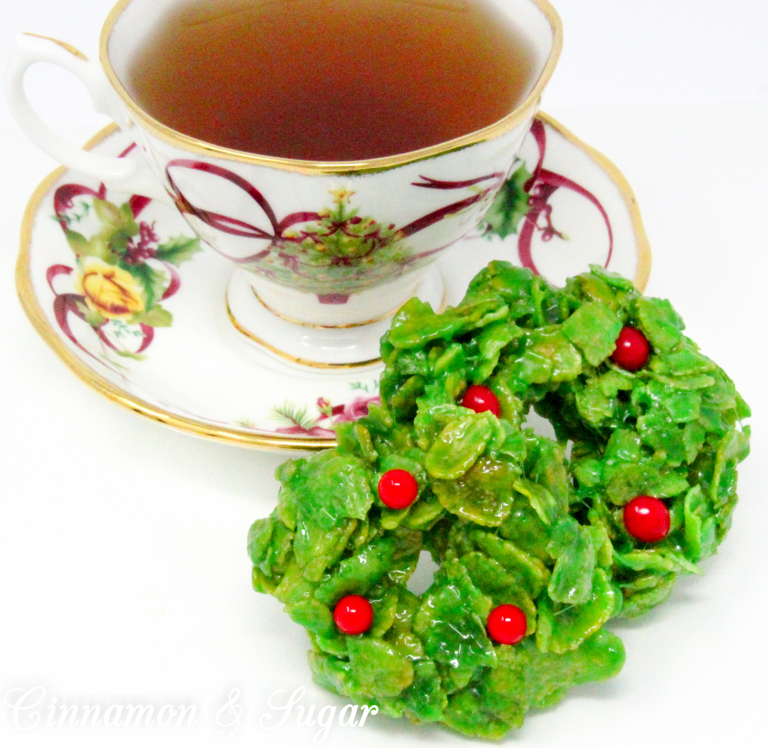 No-Bake Hollyberry Cluster Cookies epitomize hollyberries Christmas! Similar to rice krispie treats, except using cornflakes, these cookies are sure to please the kids. Recipe shared with permission granted by Sharon Farrow, author of HOLLYBERRY HOMICIDE.