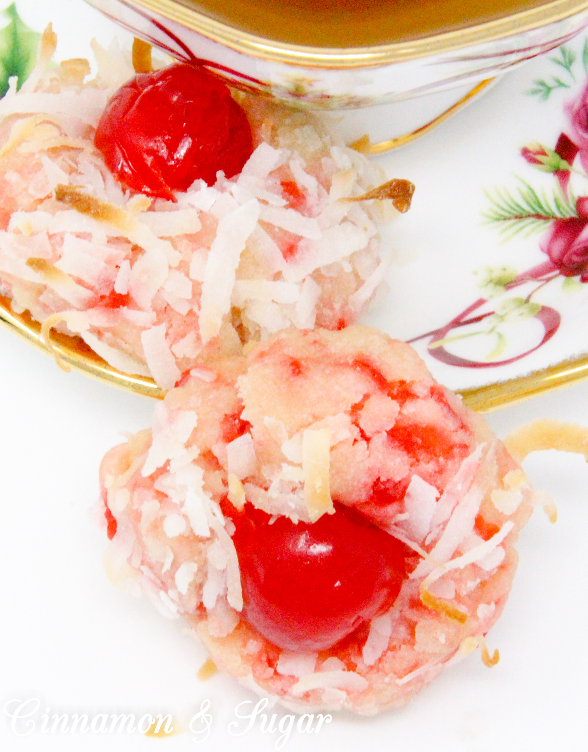 With snowy white coconut and glistening red cherries, shortbread-style Yuletide Coconut Cherry Cookies add holiday cheer to Christmas cookie platters. Recipe created by Cinnamon & Sugar for Deborah Garner, author of YULETIDE AT MOONGLOW. 