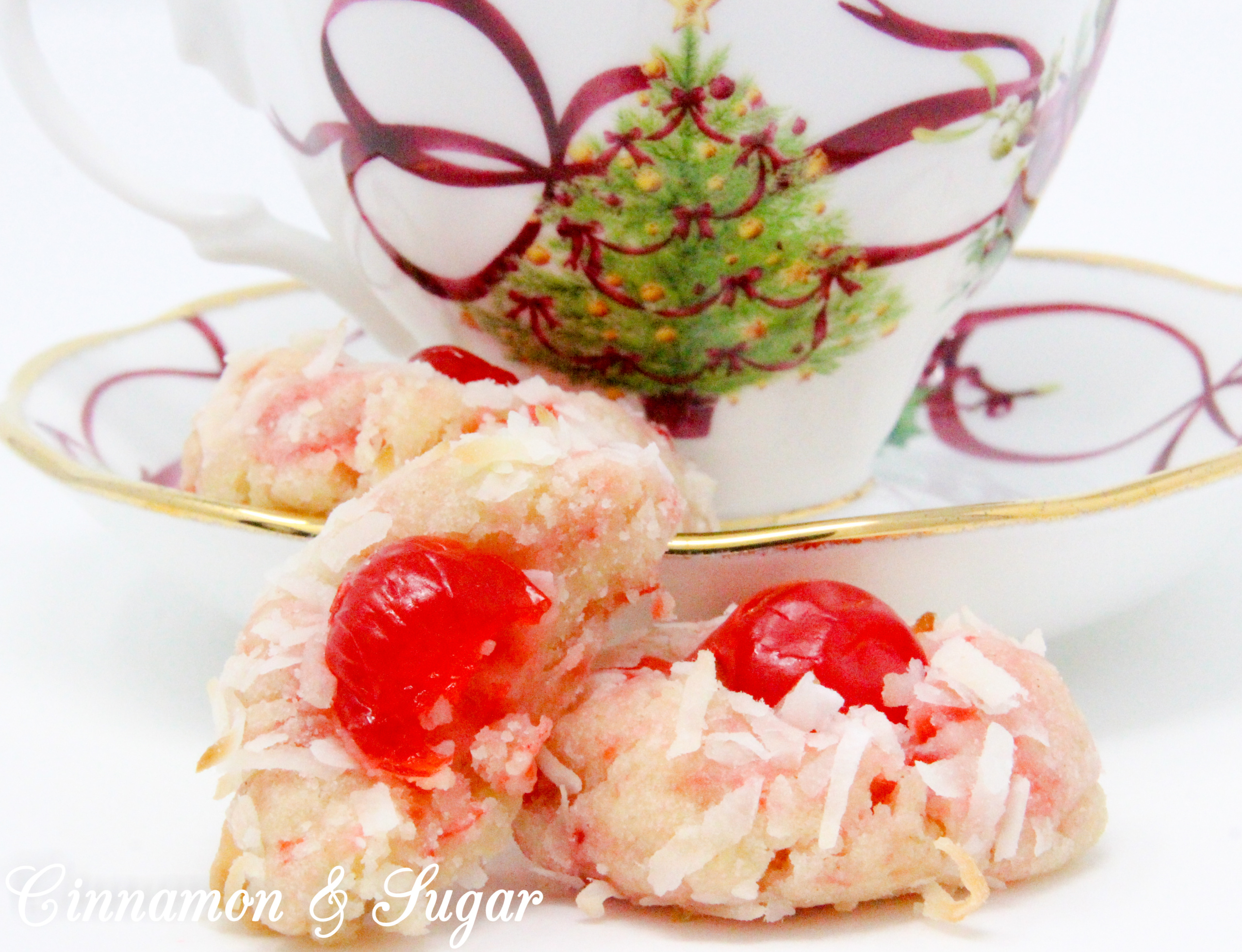 With snowy white coconut and glistening red cherries, shortbread-style Yuletide Coconut Cherry Cookies add holiday cheer to Christmas cookie platters. Recipe created by Cinnamon & Sugar for Deborah Garner, author of YULETIDE AT MOONGLOW. 