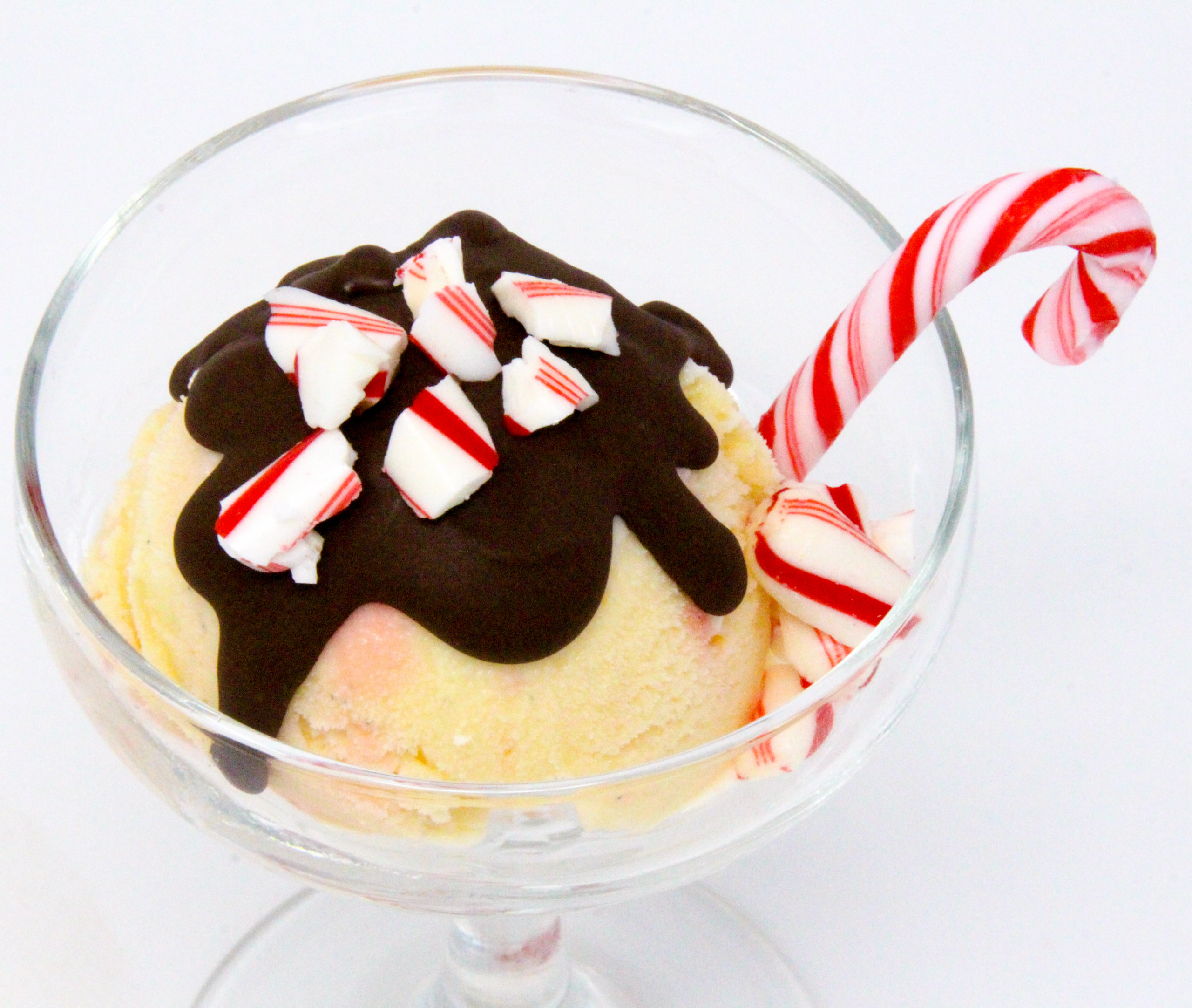 Peppermint Candy Ice Cream is ultra rich and ultra flavorful thanks to a generous amount of peppermint candies and peppermint extract! With a drizzle of chocolate, this is swoon worthy. Recipe shared with permission granted by Abby Collette, author of A GAME OF CONES.
