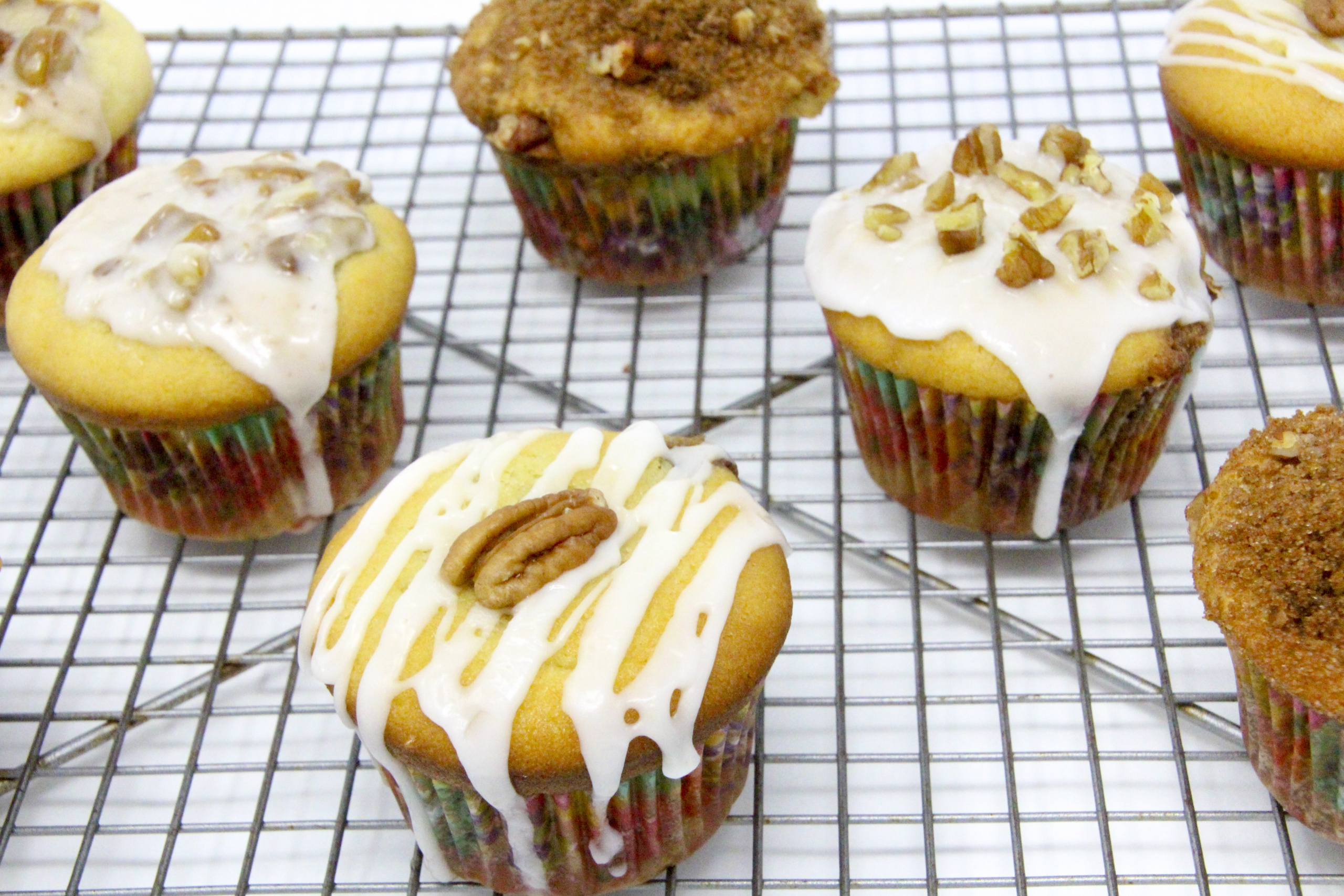 Sour Cream Pecan Coffee Cake Muffins are rich and tender, thanks to a generous amount of sour cream, while the addition of brown sugar, cinnamon, and pecans layered in the center of the muffins make these extra delicious. Recipe shared with permission granted by S.C. Perkins, author of FATAL FAMILY TIES.