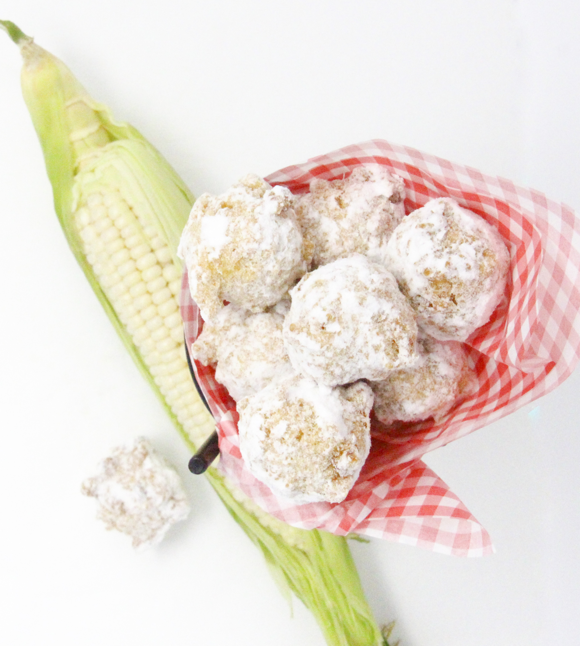 Corny Fritters can be served savory, spicy, or sweet depending on individual tastes. Fairly simple using canned or frozen corn, and a few other pantry and dairy staples, these delicious bites are quick to make. Recipe shared with permission granted by Ginger Bolton, author of BEYOND A REASONABLE DONUT. 