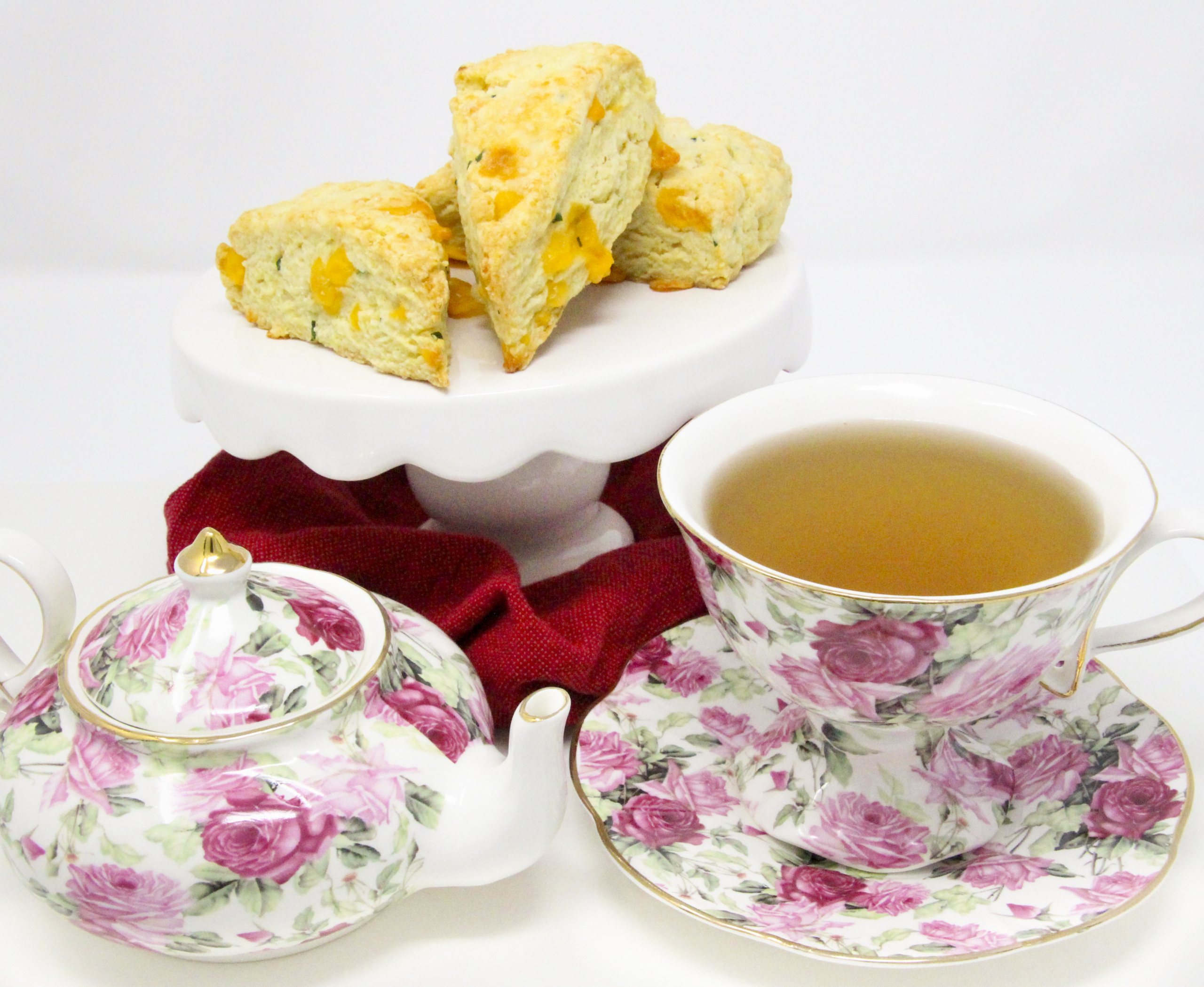 A delectable combination of flaky pastry, two kinds of cheese, and chives, Savory Cheese Scones are the perfect accompaniment to serve with a warming bowl of soup or even used as sandwich bread for lunch or a light supper. Recipe shared with permission granted by Kate Carlisle, author of LITTLE BLACK BOOK. 