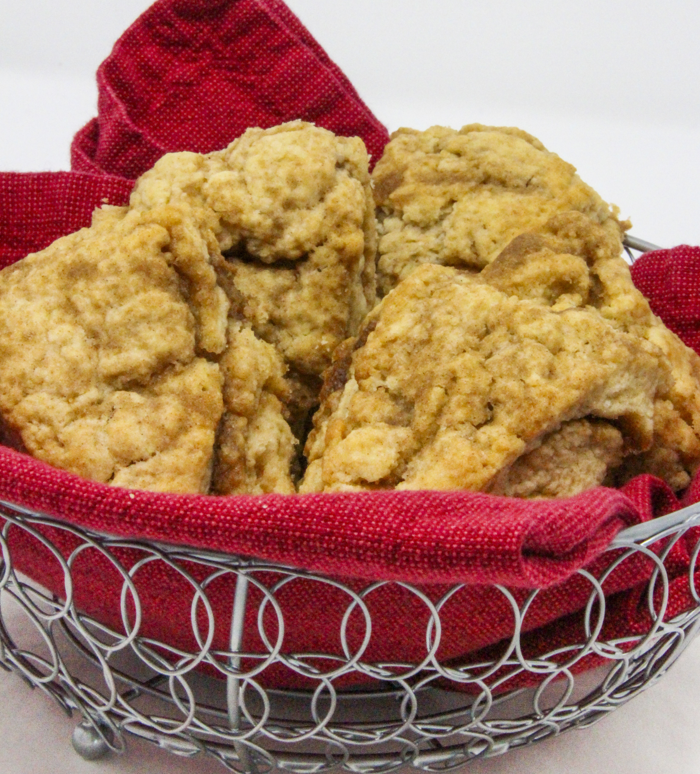 These melt-in-your-mouth flaky Cinnamon Swirl Scones are chock full of flavor thanks to a generous amount of cinnamon and brown sugar. Recipe shared with permission granted by Daryl Wood Gerber, author of A GLIMMER OF A CLUE.