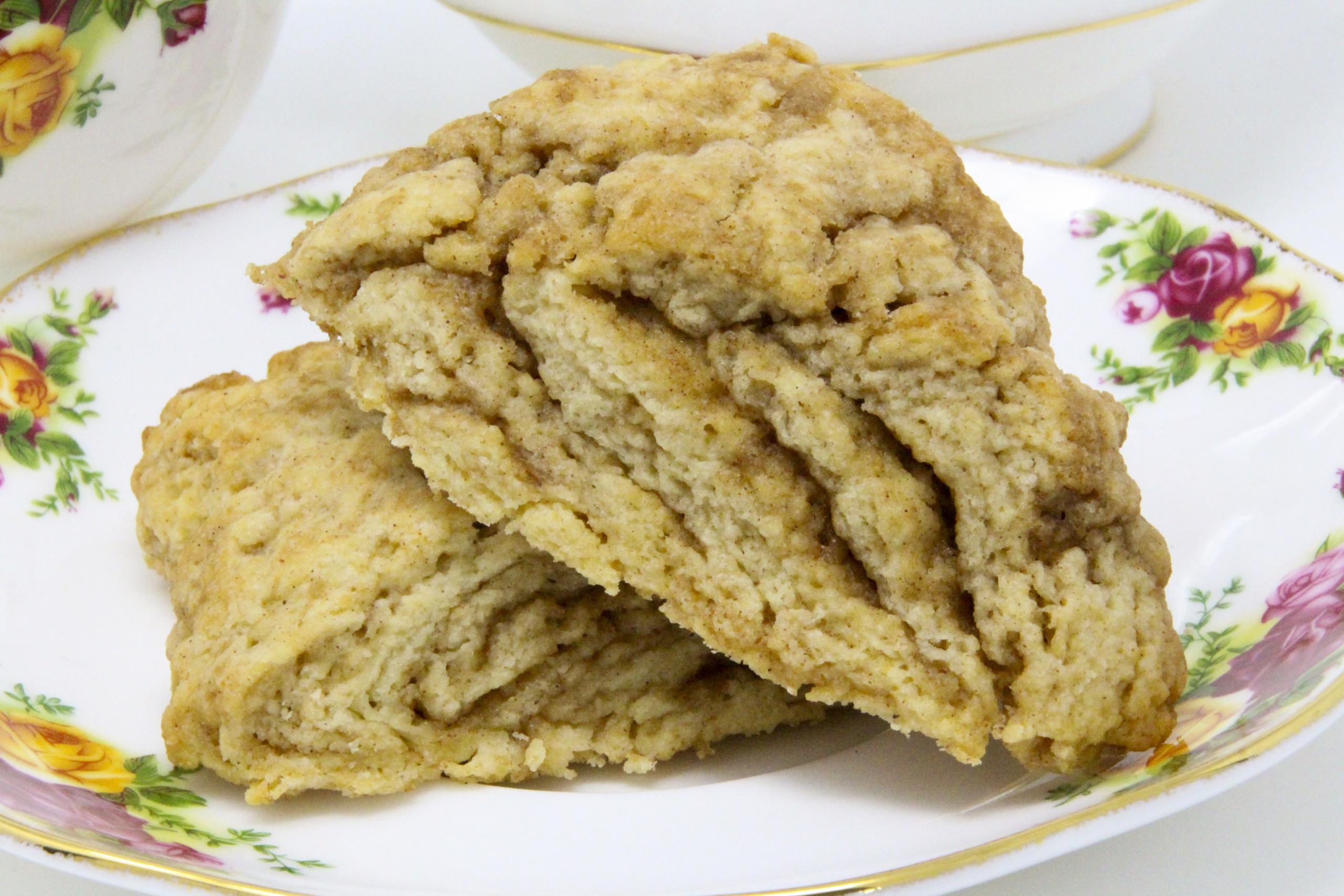 These melt-in-your-mouth flaky Cinnamon Swirl Scones are chock full of flavor thanks to a generous amount of cinnamon and brown sugar. Recipe shared with permission granted by Daryl Wood Gerber, author of A GLIMMER OF A CLUE.