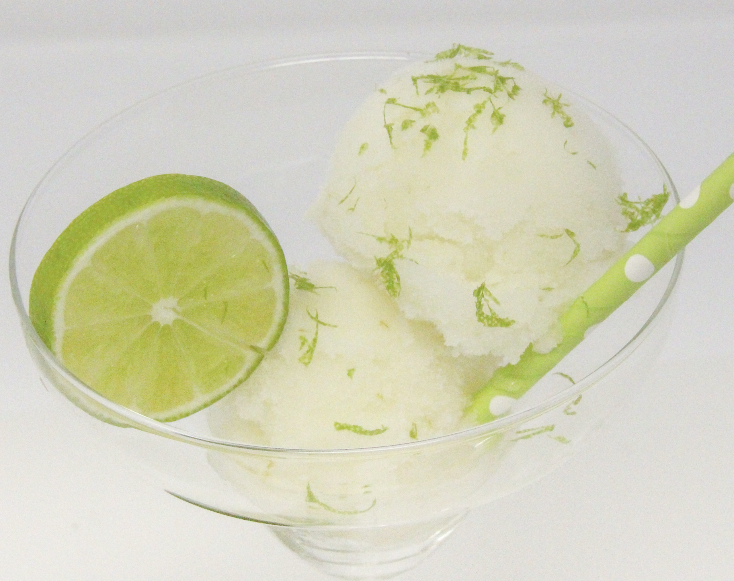 A tart-sweet lime sorbet with a kick from tequila and triple sec, this Ultimate Frozen Margarita captures the essence of summer! Recipe shared with permission granted by Meri Allan, author of THE ROCKY ROAD TO RUIN. 