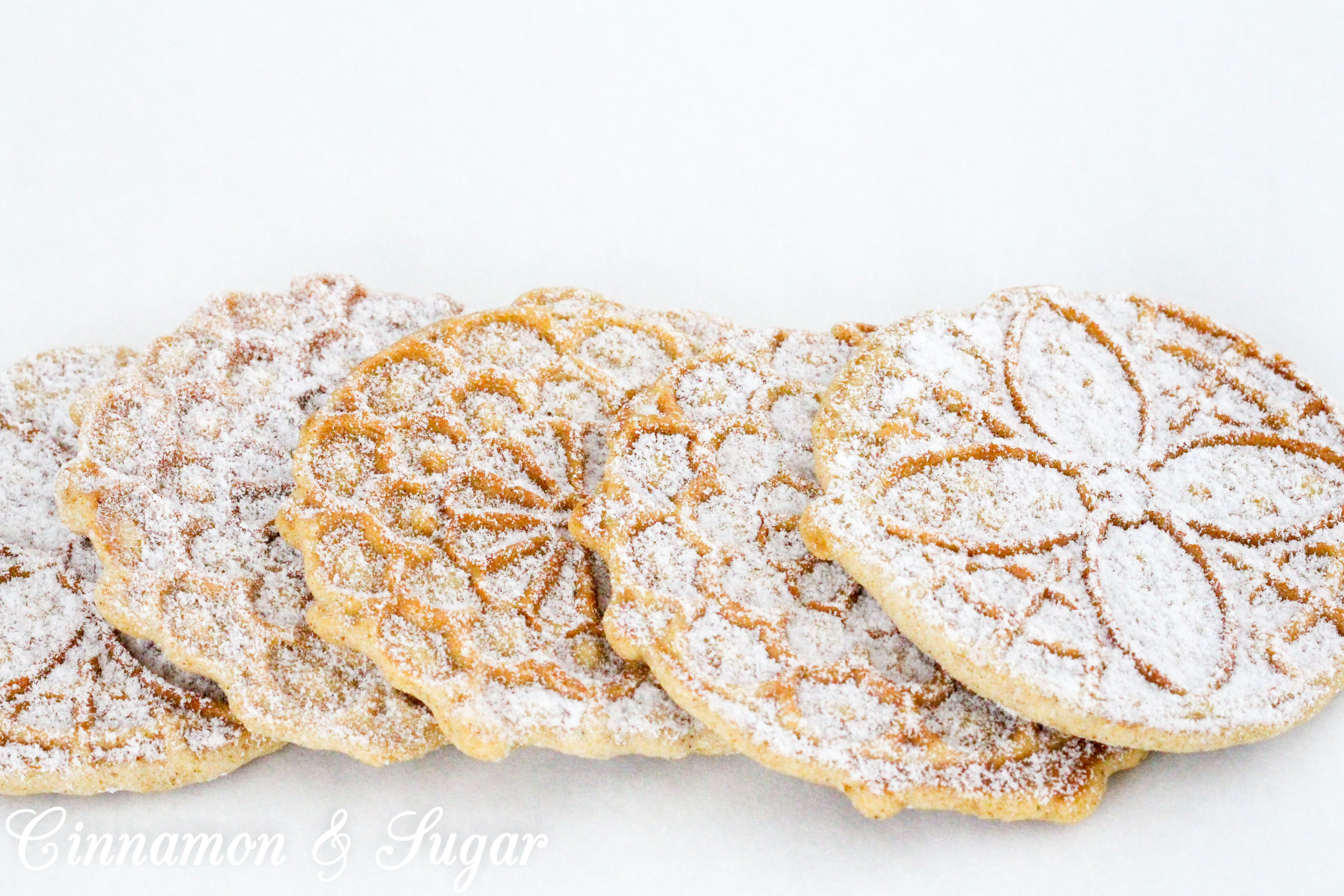 Warming spices and sugary goodness will make your kitchen smell like Christmas when you make these Gingerbread Pizzelles! Recipe created by Cinnamon & Sugar for Catherine Bruns, author of THE ENEMY YOU GNOCCHI.