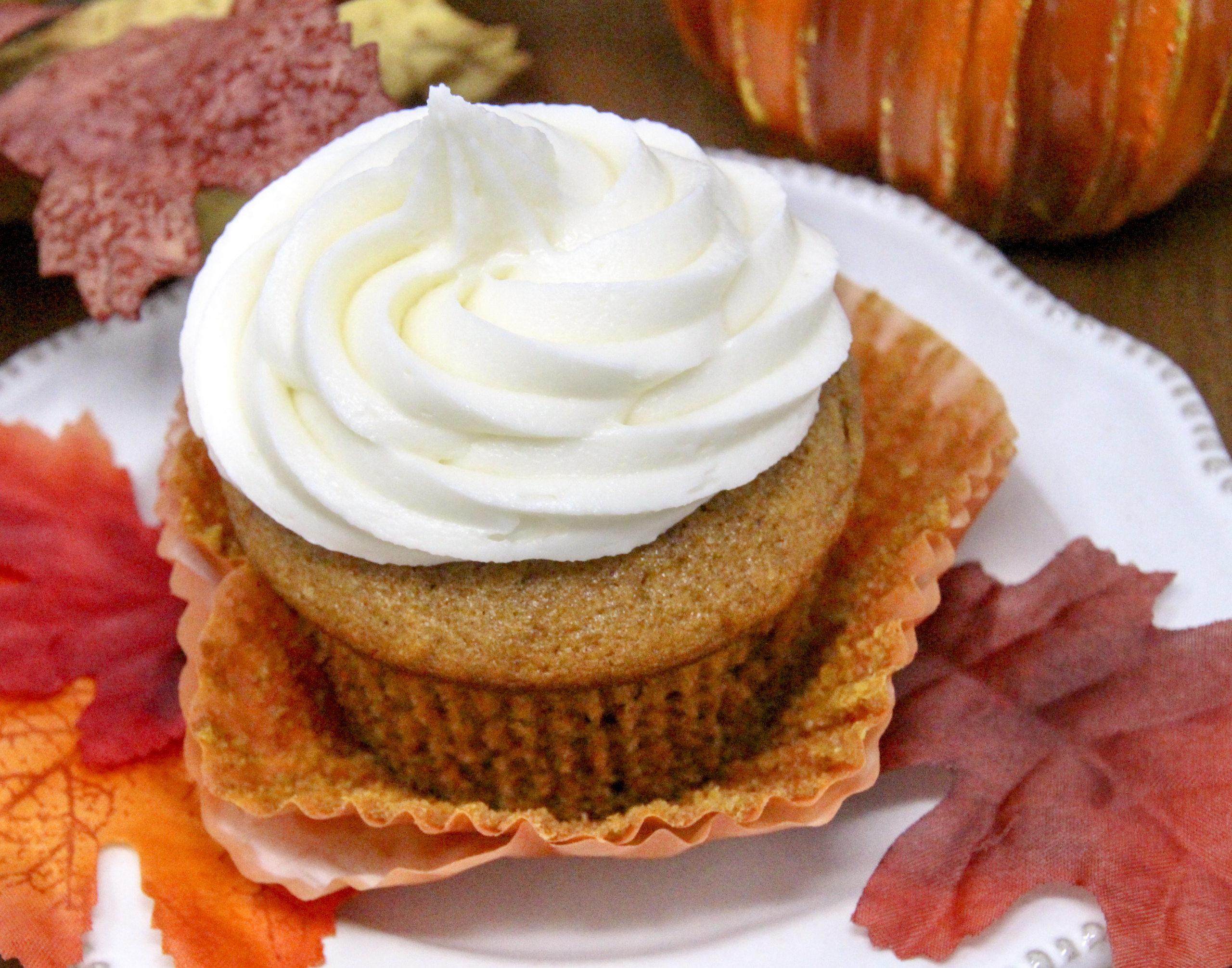 Rich and moist, the warm flavors of these Pumpkin Cupcakes with Cream Cheese Frosting hits the mark for bringing to mind chilly fall days and looking forward to jack-o-lanterns and trick-or-treaters. Recipe shared with permission granted by Krista Davis, author of MURDER OUTSIDE THE LINES.