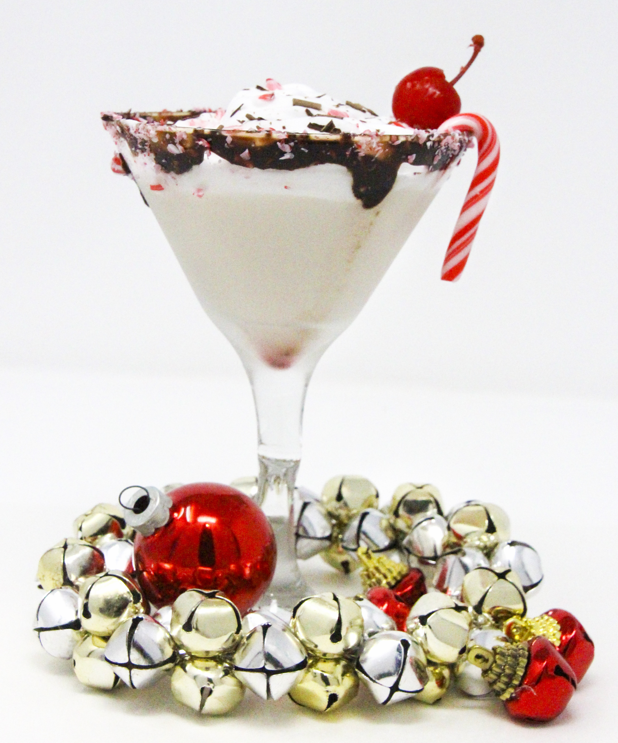 Peppy Schnappy Blast hits all the right marks for a Christmas cocktail: spirited candy cane flavors, creamy vanilla, chocolate, and whipped cream with a cherry on top! Recipe shared with permission granted by James J. Cudney, author of SLEIGH BELL TOWER.