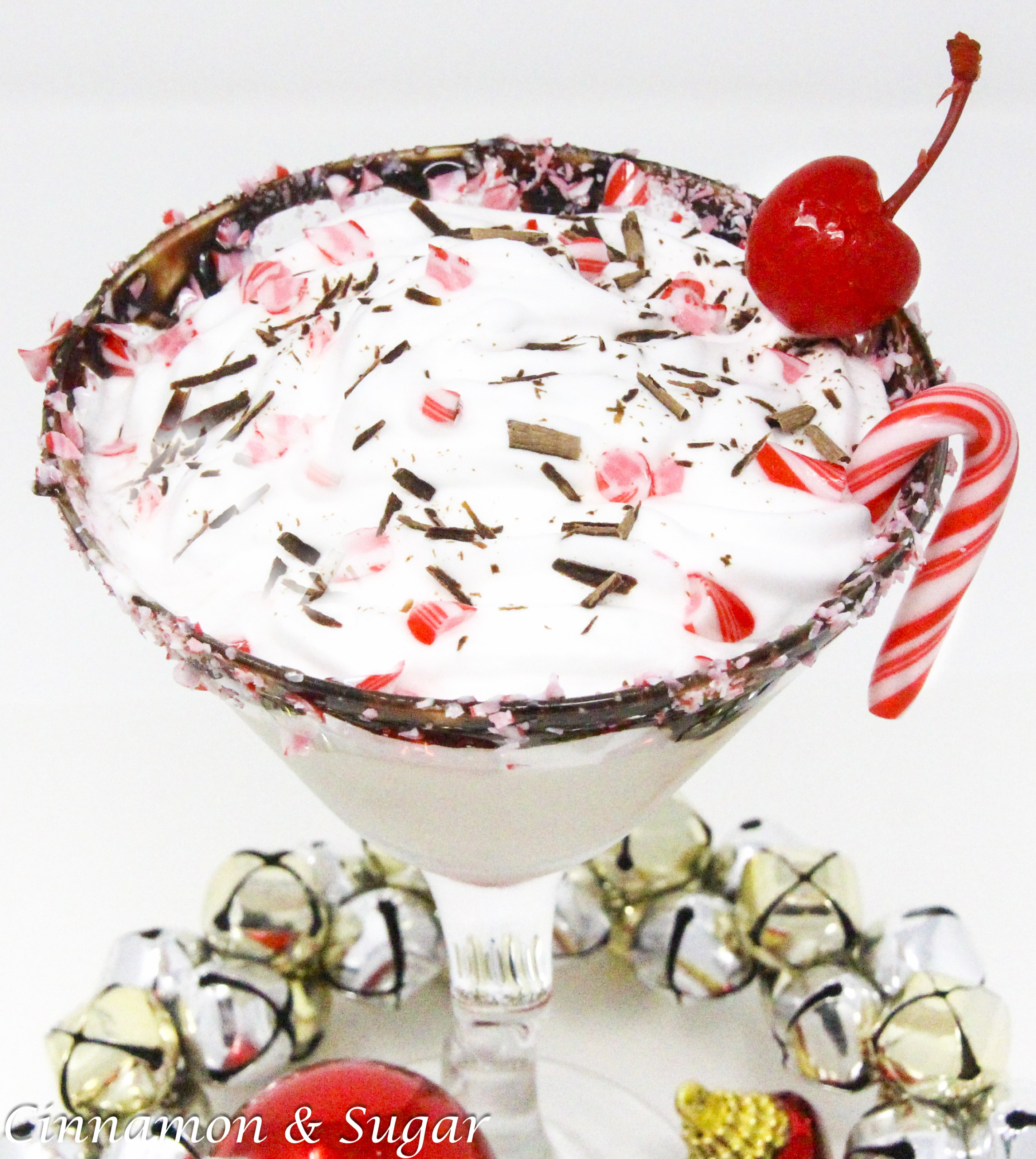 Peppy Schnappy Blast hits all the right marks for a Christmas cocktail: spirited candy cane flavors, creamy vanilla, chocolate, and whipped cream with a cherry on top! Recipe shared with permission granted by James J. Cudney, author of SLEIGH BELL TOWER.