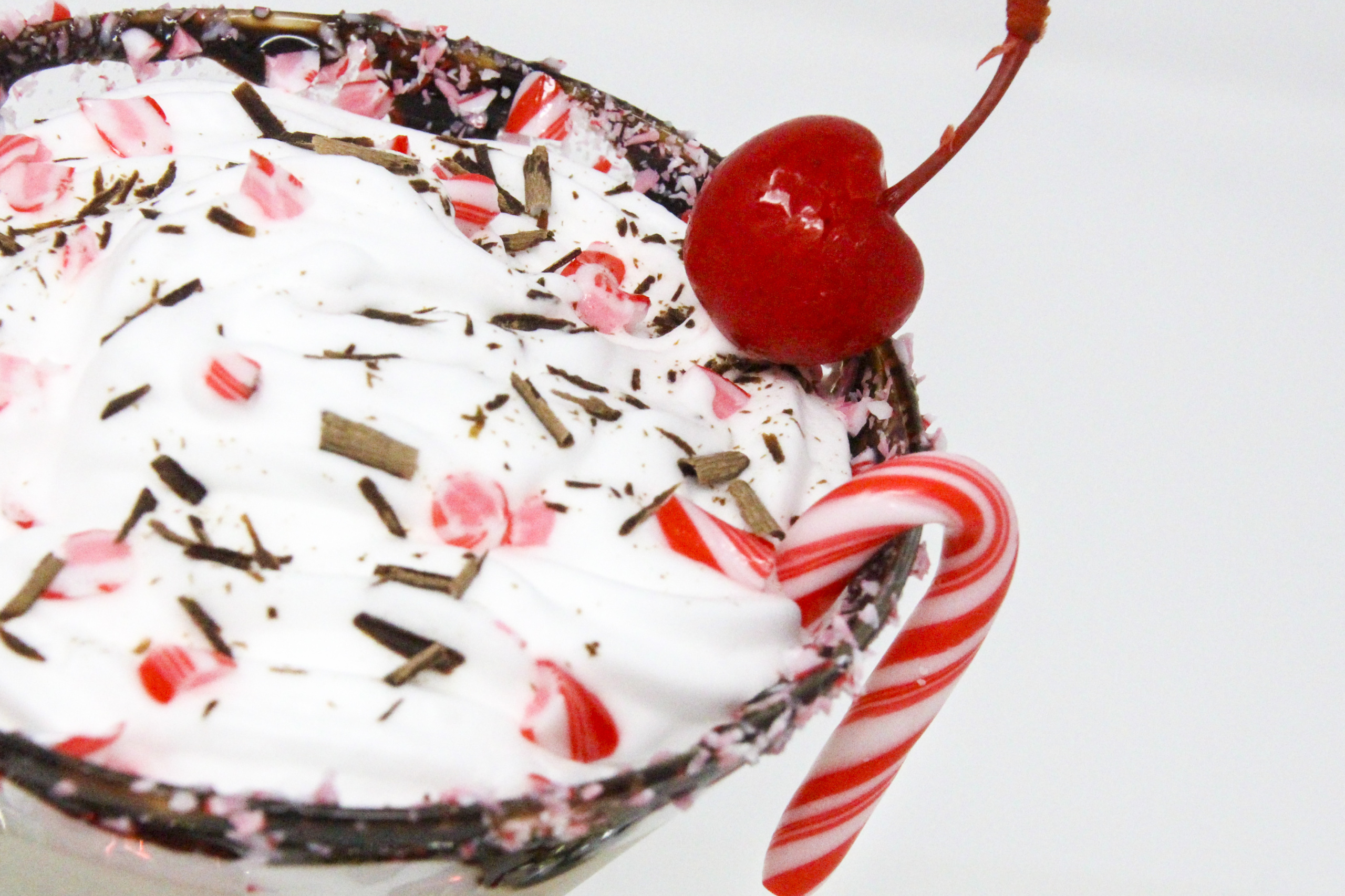 Peppy Schnappy Blast hits all the right marks for a Christmas cocktail: spirited candy cane flavors, creamy vanilla, chocolate, and whipped cream with a cherry on top! Recipe shared with permission granted by James J. Cudney, author of SLEIGH BELL TOWER.