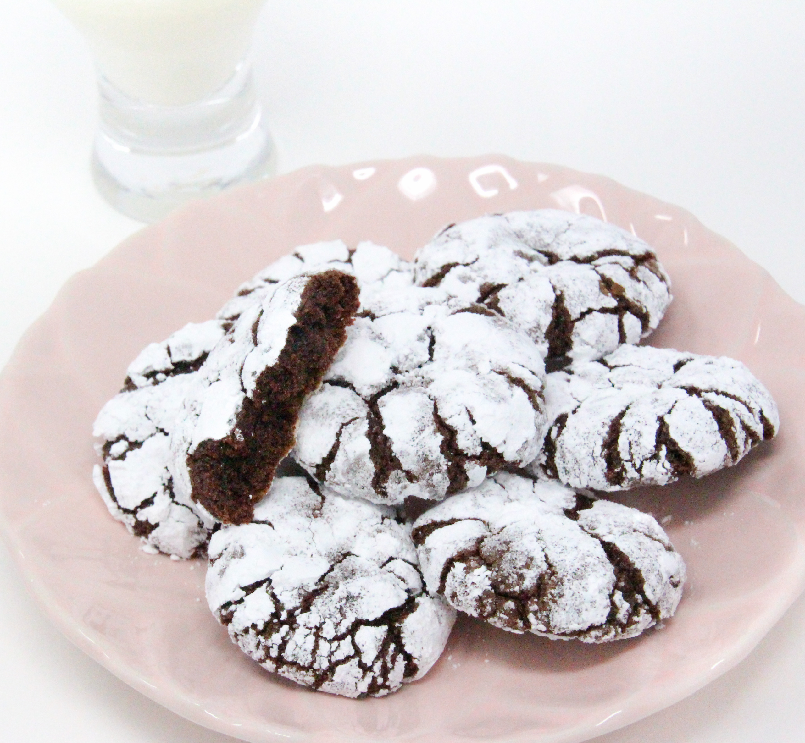 Chocolate Crinkles are rolled into both granulated and powdered sugar before baking, giving the cookies a crisp edge and a fudgy interior cookie - heavenly! Recipe shared with permission granted by Daryl Wood Gerber, author of A HINT OF MISCHIEF.