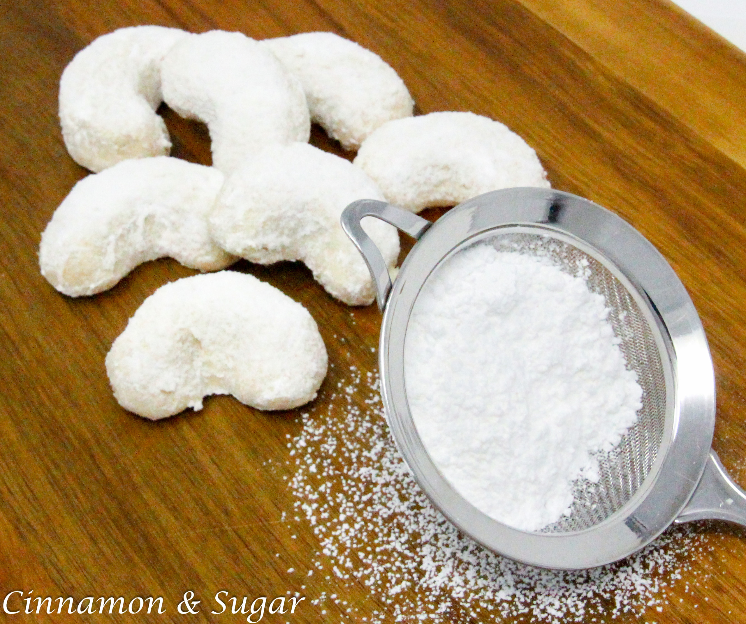 Katie’s Wedding Cookies are easy to mix up and the mild, crunchy cashews complements the flaky cookie base. The cookie itself isn’t overly sweet, so the extra coating of confectioners’ sugar provides the perfect balance. Recipe shared with permission granted by Daryl Wood Gerber, author of SIMMERING WITH RESENTMENT. 