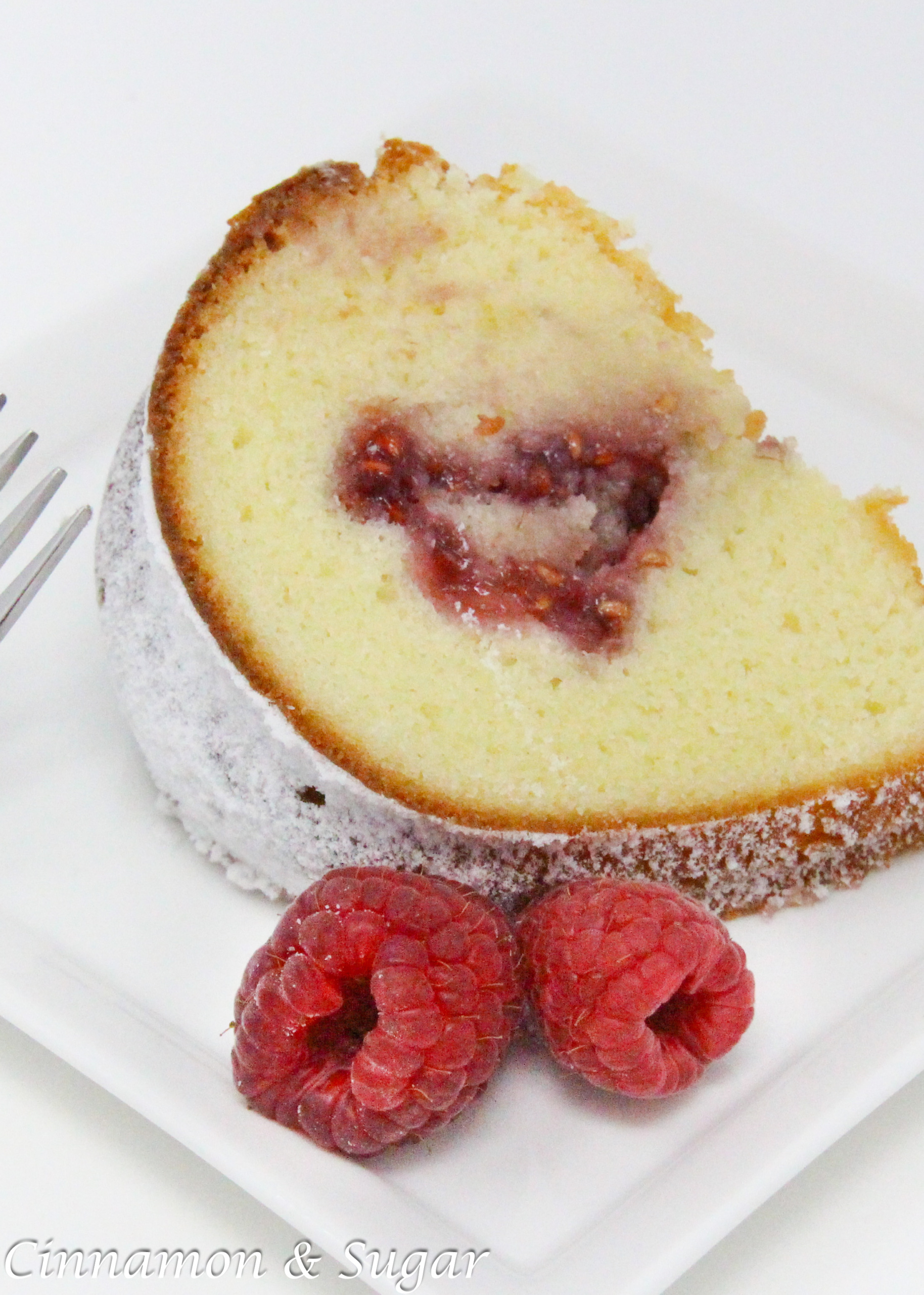 Portuguese Yogurt Cake is moist with a delicate flavor lending itself to versatility by swirling in your favorite jam or chocolate chips. With a quick sprinkle of powdered sugar and a handful of fresh raspberries for garnish, this makes a delicious dessert to serve on any occasion. Recipe shared with permission granted by Mary Jane Maffini, author of DEATH PLANS A PERFECT TRIP. 