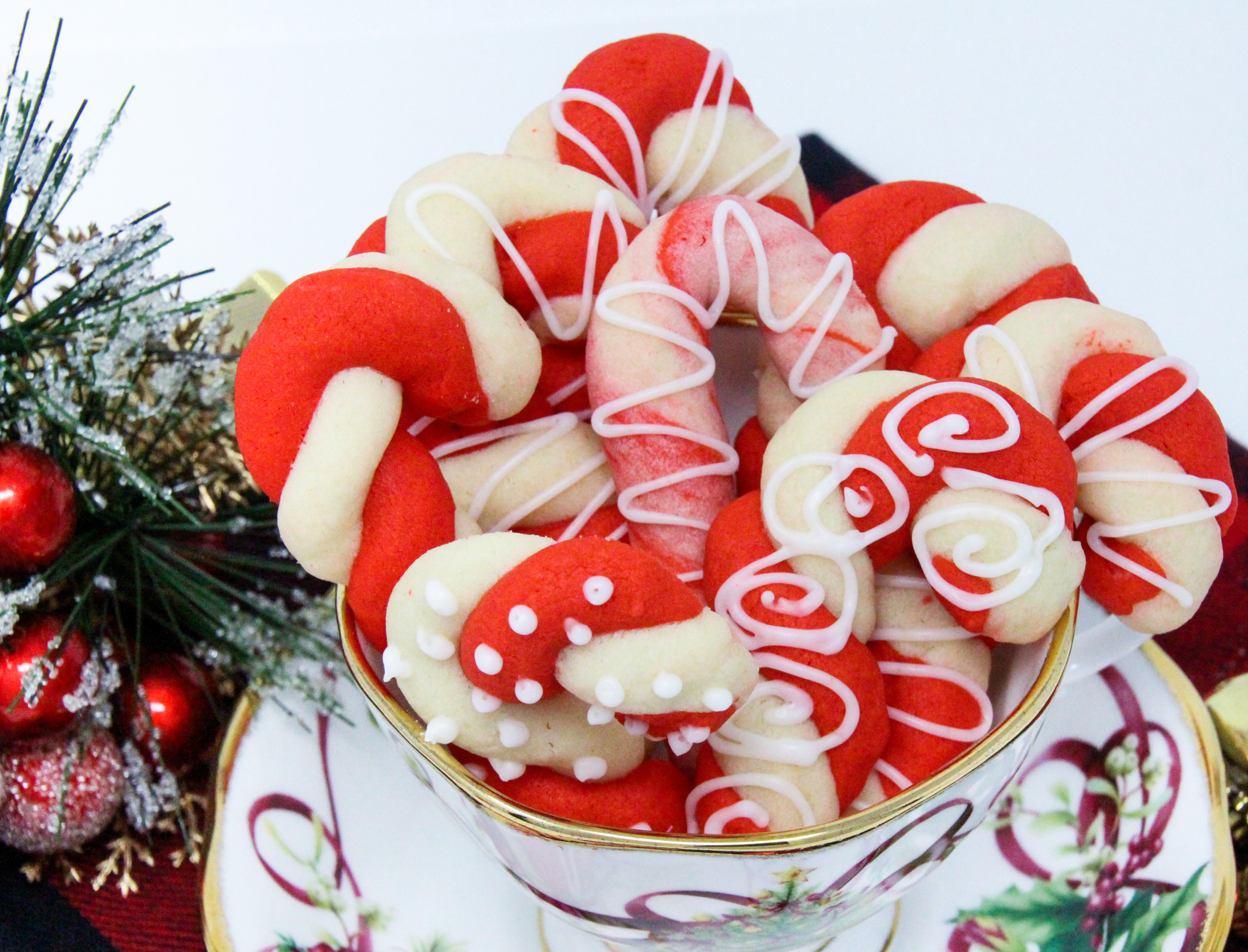 The colorful twists of the peppermint, and red Candy Cane cookies will add a delicious and jolly look to your holiday cookie platter! Recipe shared with permission granted by Leslie Budewitz, author of PEPPERMINT BARKED. 