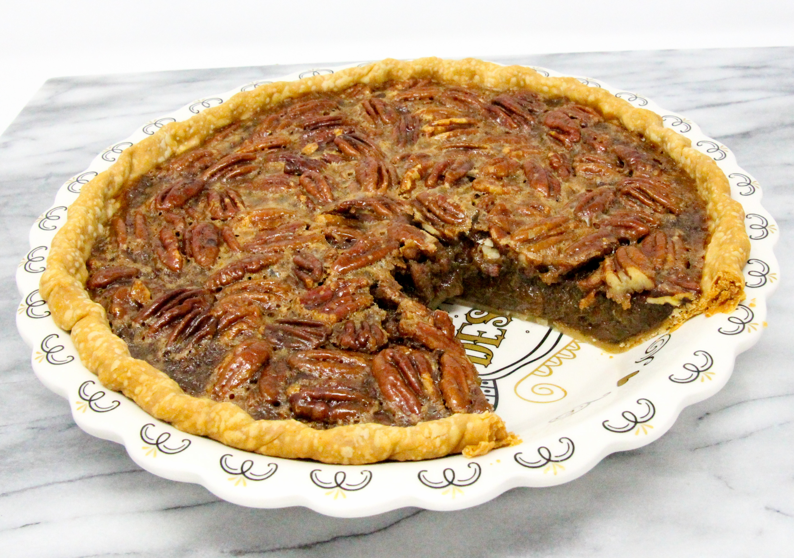 Cardamom Pecan Pie has plenty of natural sweetness thanks to maple syrup and a generous amount of pecans. The hint of cardamom elevates the flavor to scrumptious! Recipe shared with permission granted by Barbara Ross, author of MUDDLED THROUGH.