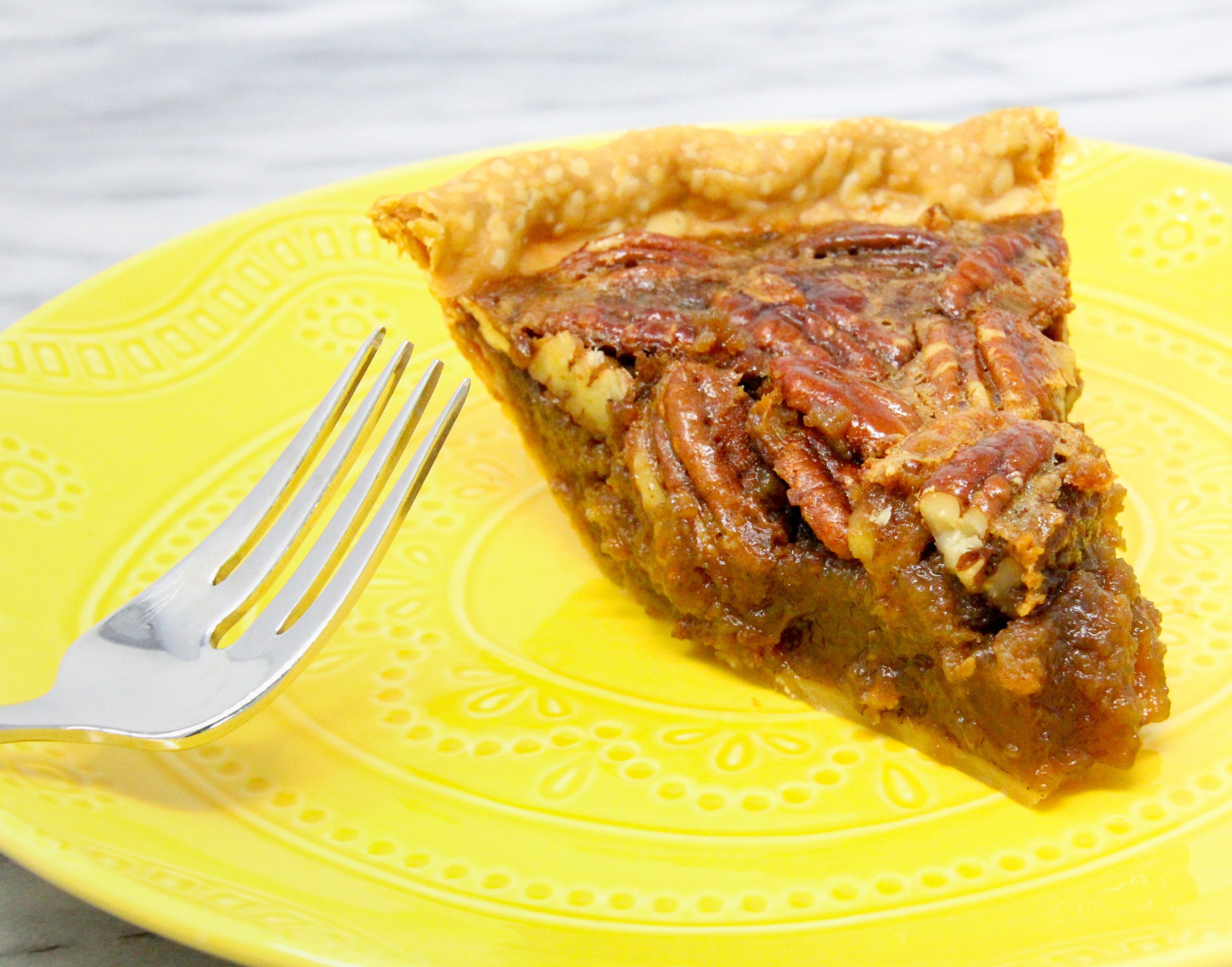 Cardamom Pecan Pie has plenty of natural sweetness thanks to maple syrup and a generous amount of pecans. The hint of cardamom elevates the flavor to scrumptious! Recipe shared with permission granted by Barbara Ross, author of MUDDLED THROUGH.