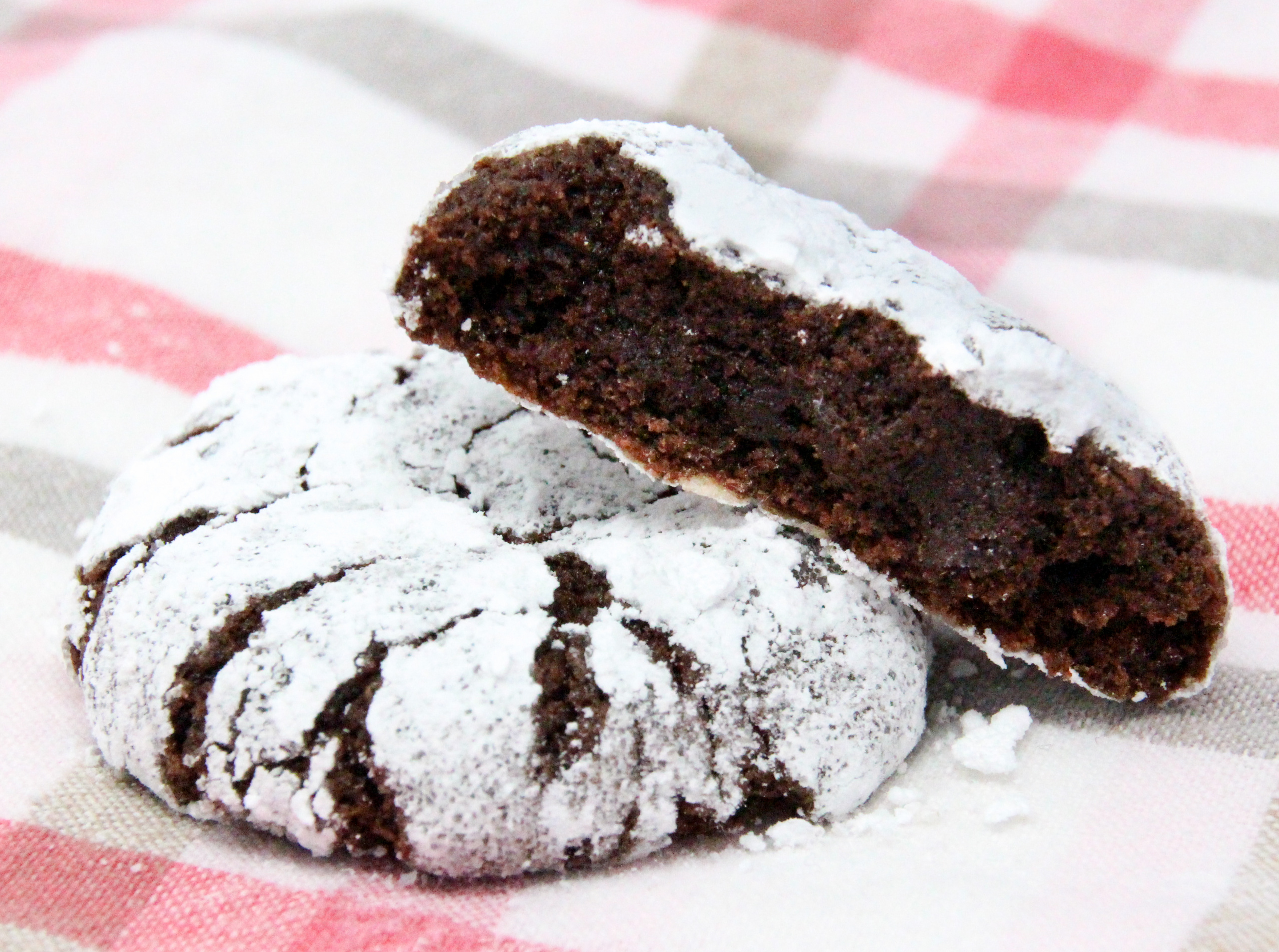 Chocolate Crinkles are rolled into both granulated and powdered sugar before baking, giving the cookies a crisp edge and a fudgy interior cookie - heavenly! Recipe shared with permission granted by Daryl Wood Gerber, author of A HINT OF MISCHIEF.