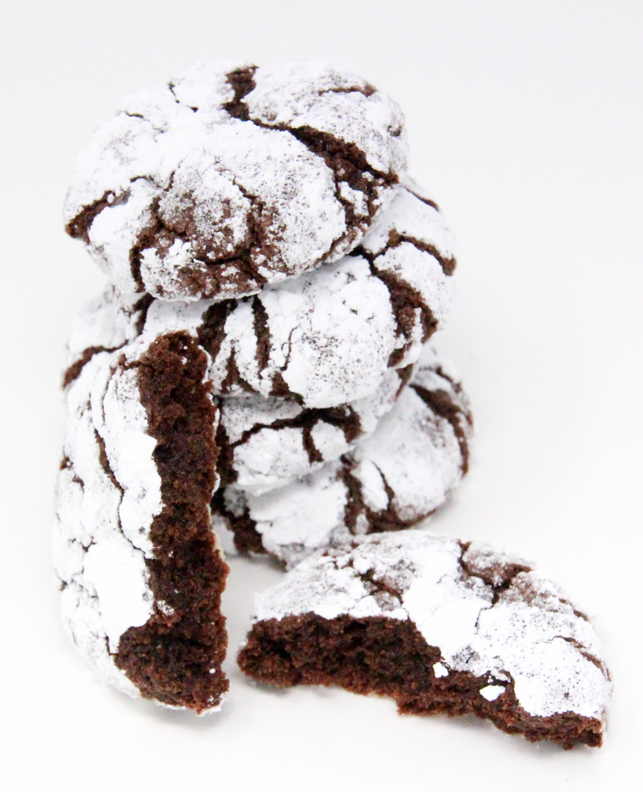 Chocolate Crinkles are rolled into both granulated and powdered sugar before baking, giving the cookies a crisp edge and a fudgy interior cookie - heavenly! Recipe shared with permission granted by Daryl Wood Gerber, author of A HINT OF MISCHIEF.