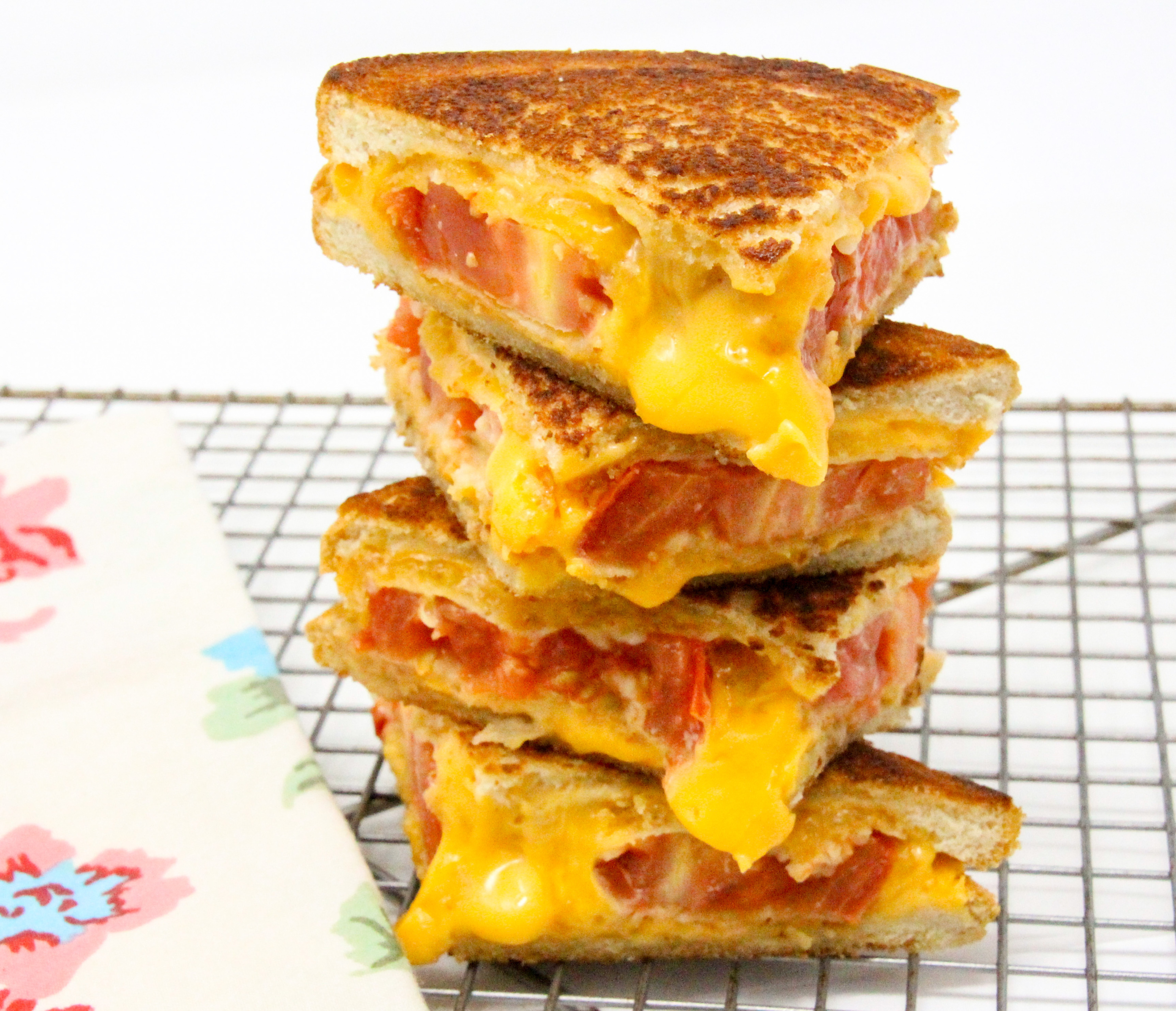 Alvin’s Panko Perfection grilled cheese sandwich features sun-ripened tomatoes coated with crunchy panko, tangy Parmesan, and oozing, melted sharp cheddar cheese. Recipe shared with permission granted by Linda Reilly, author of NO PARM NO FOUL.