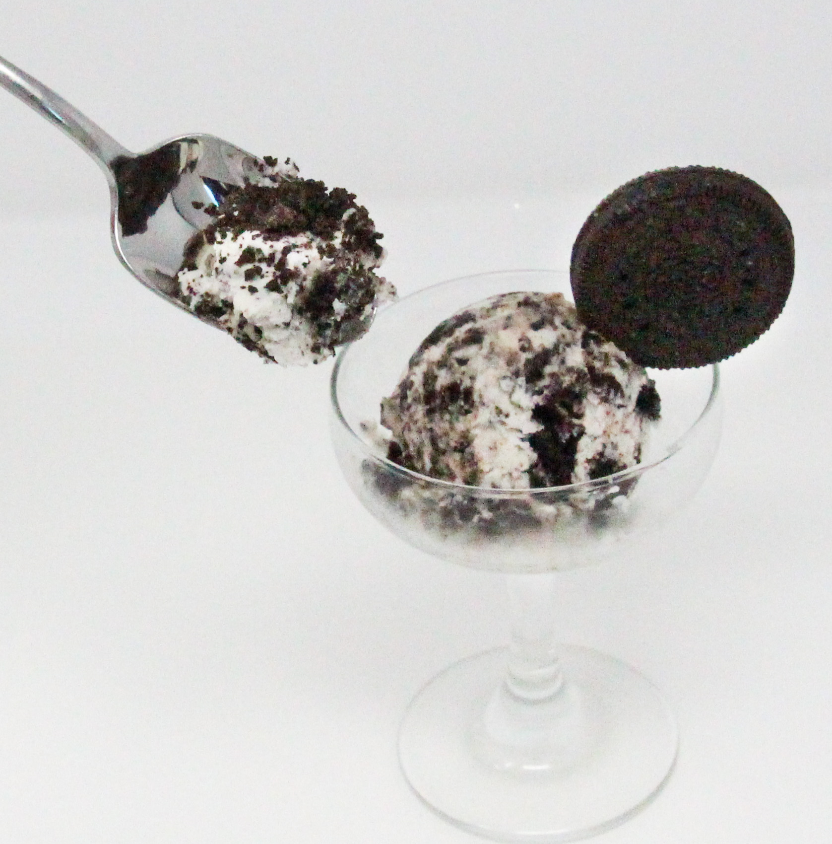 Gramma's Easy Oreo Ice Cream uses only four simple ingredients and an electric mixer. Once frozen, the resulting concoction is pure deliciousness! Recipe shared with permission granted by Lee Hollis, author of DEATH OF AN ICE CREAM SCOOPER. 