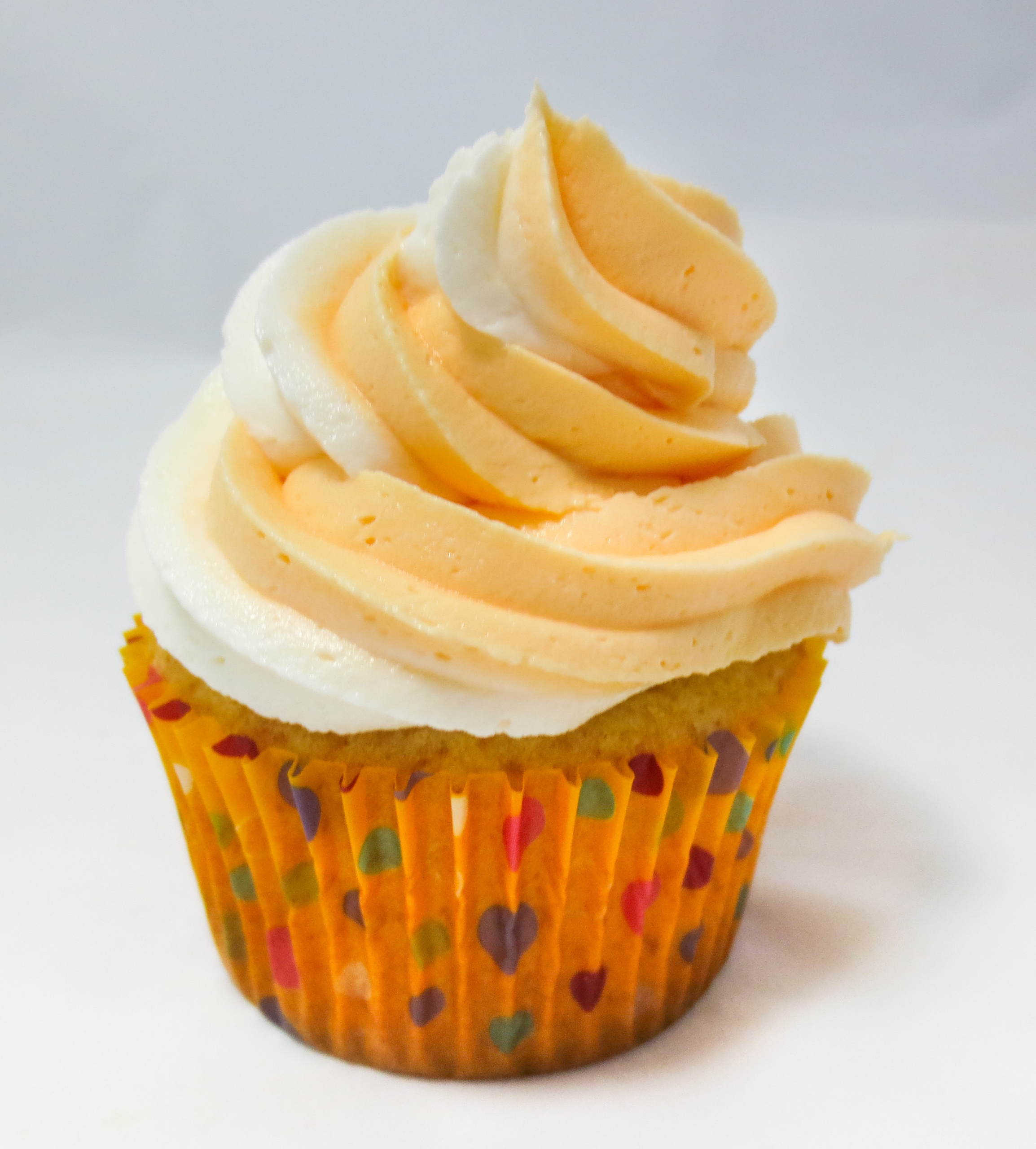 Orange Dreamsicle Cupcakes are moist, delicious orange cupcakes topped with a dreamy vanilla buttercream frosting. Reminiscent of a childhood favor ice cream treat, these cupcakes are sure to be a hit with young and old alike! Recipe shared with permission granted by Jenn McKinlay, author of BUTTERCREAM BUMP OFF.