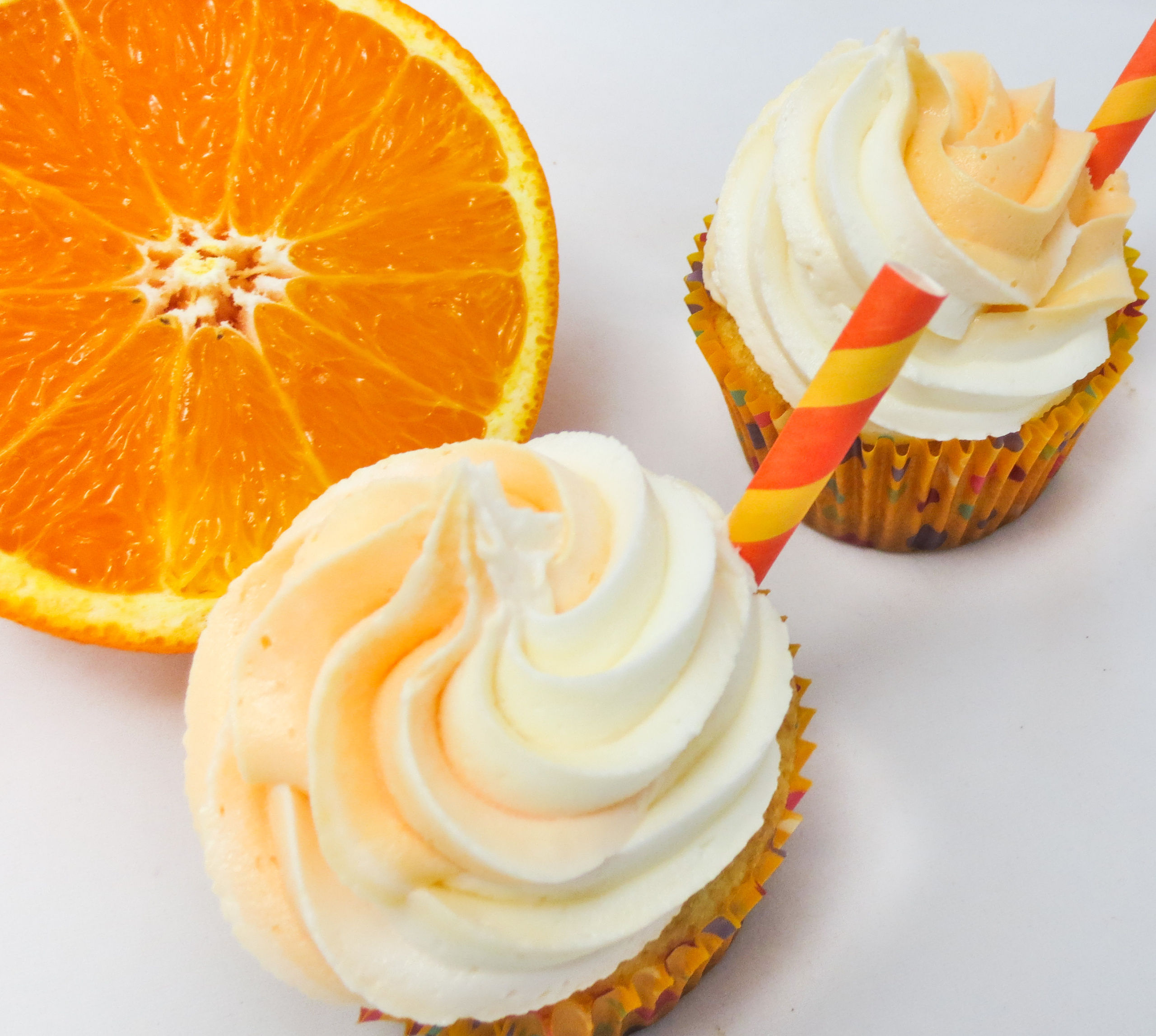 Orange Dreamsicle Cupcakes are moist, delicious orange cupcakes topped with a dreamy vanilla buttercream frosting. Reminiscent of a childhood favor ice cream treat, these cupcakes are sure to be a hit with young and old alike! Recipe shared with permission granted by Jenn McKinlay, author of BUTTERCREAM BUMP OFF.