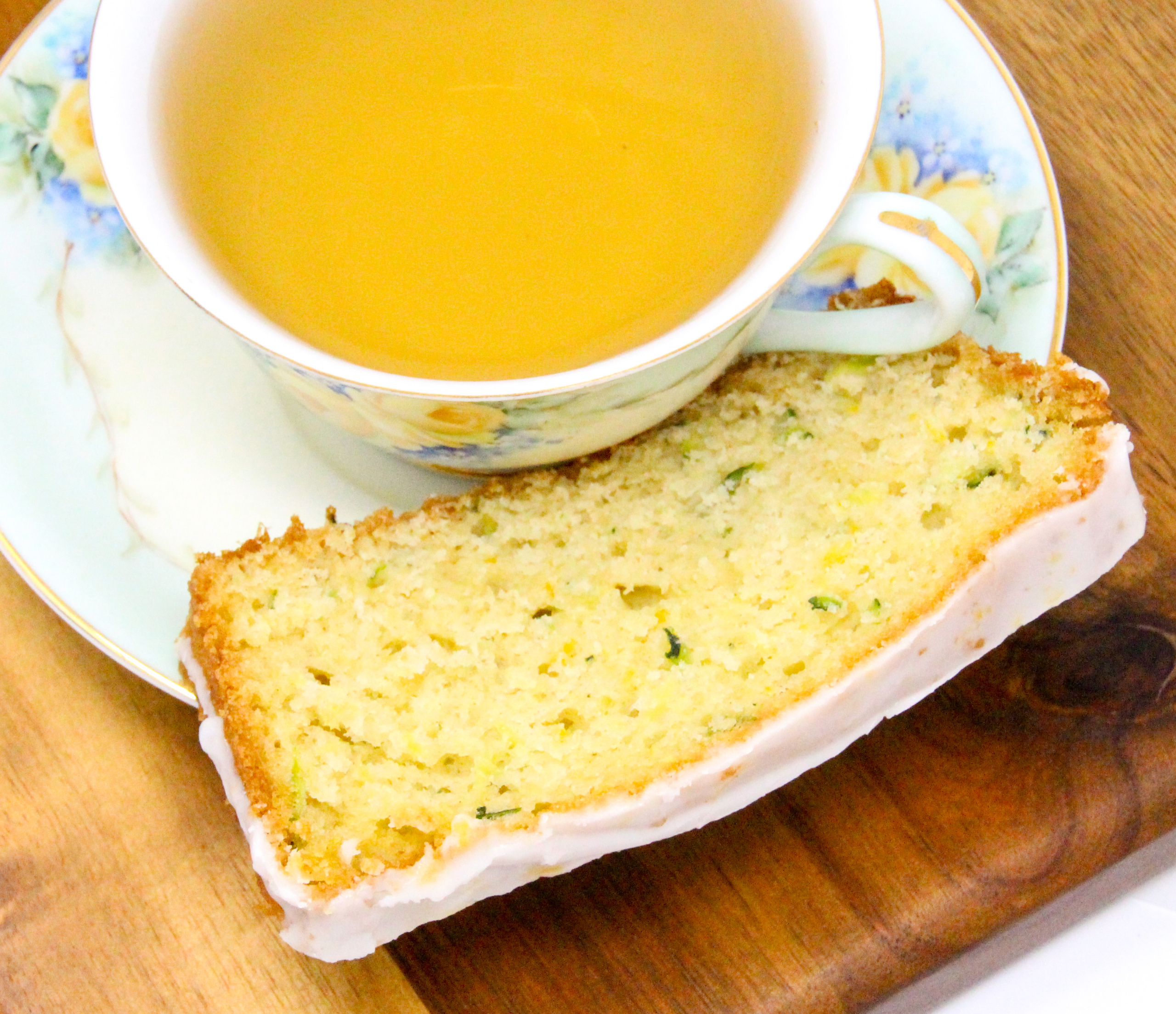 Lemon Zucchini Bread is simple to make. The lemon juice gives it a lighter flavor and the lemony glaze makes it taste indulgent. Recipe shared with permission granted by Valerie Burns, author of TWO PARTS SUGAR, ONE PART MURDER.