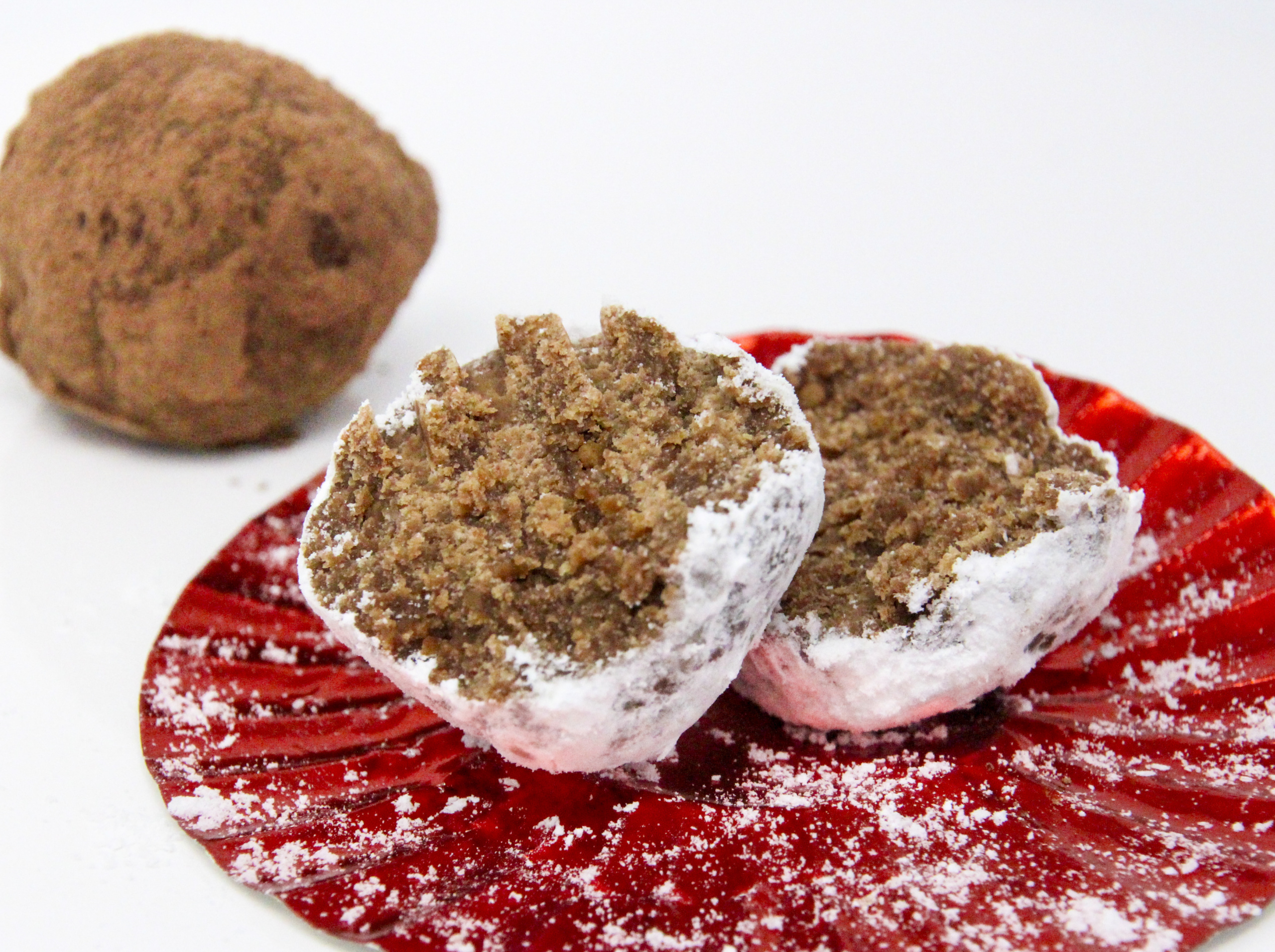 No-Bake Rum Ball Cookies only require a few simple ingredients and a quick whirl in the food process for delicious, easy to make treats. Recipe created by Cinnamon & Sugar for Catherine Bruns, author of SEASONED WITH MURDER. 