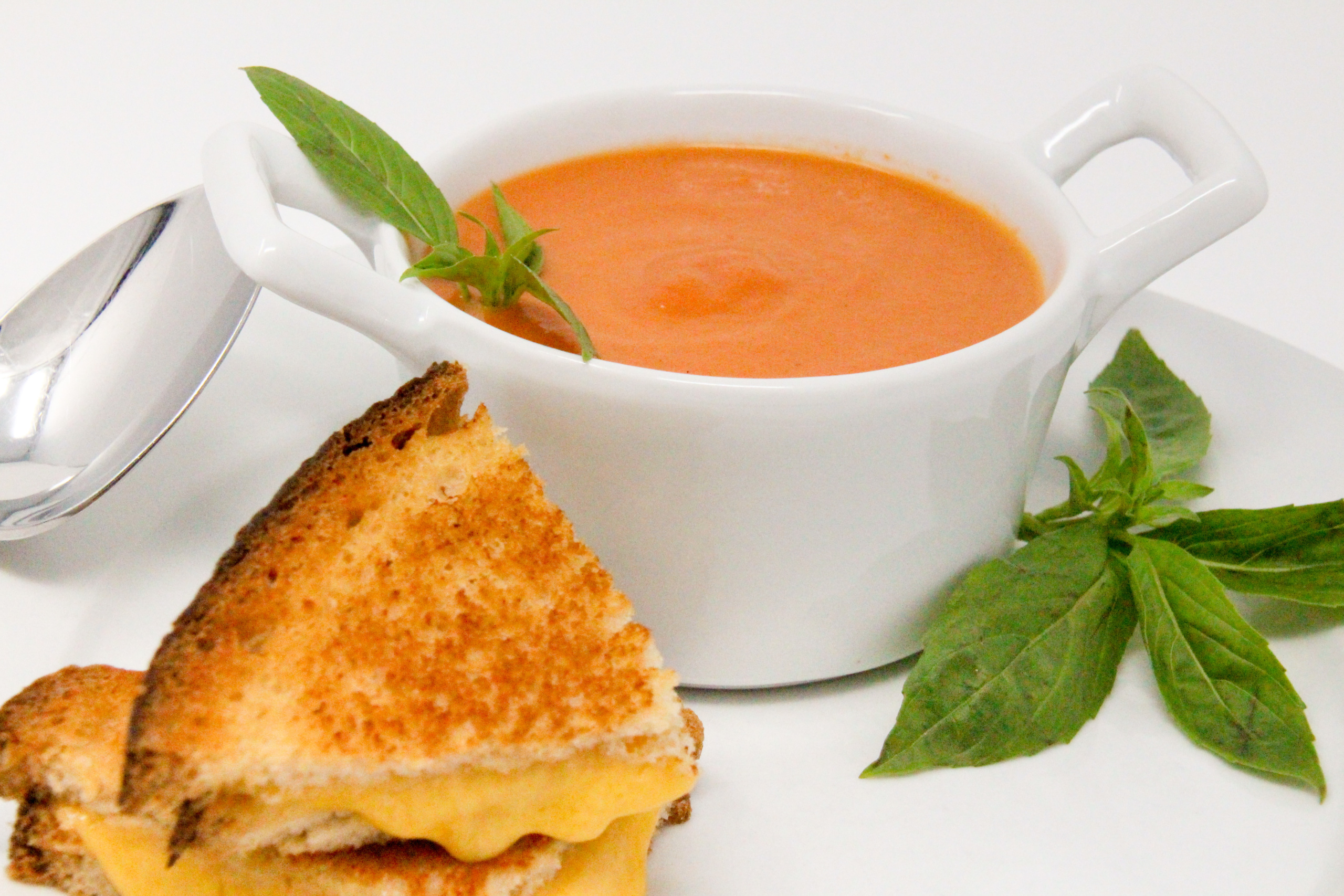 Grant's Tomato Soup uses canned San Marzano tomatoes, plus the addition of other fresh ingredients and sherry which elevates the flavor to yum. With a bit a cream, the added richness complements the tang of cheese in a grilled cheese sandwich. Recipe shared with permission granted by Linda Reilly, author of CHEDDER LATE THAN DEAD. 