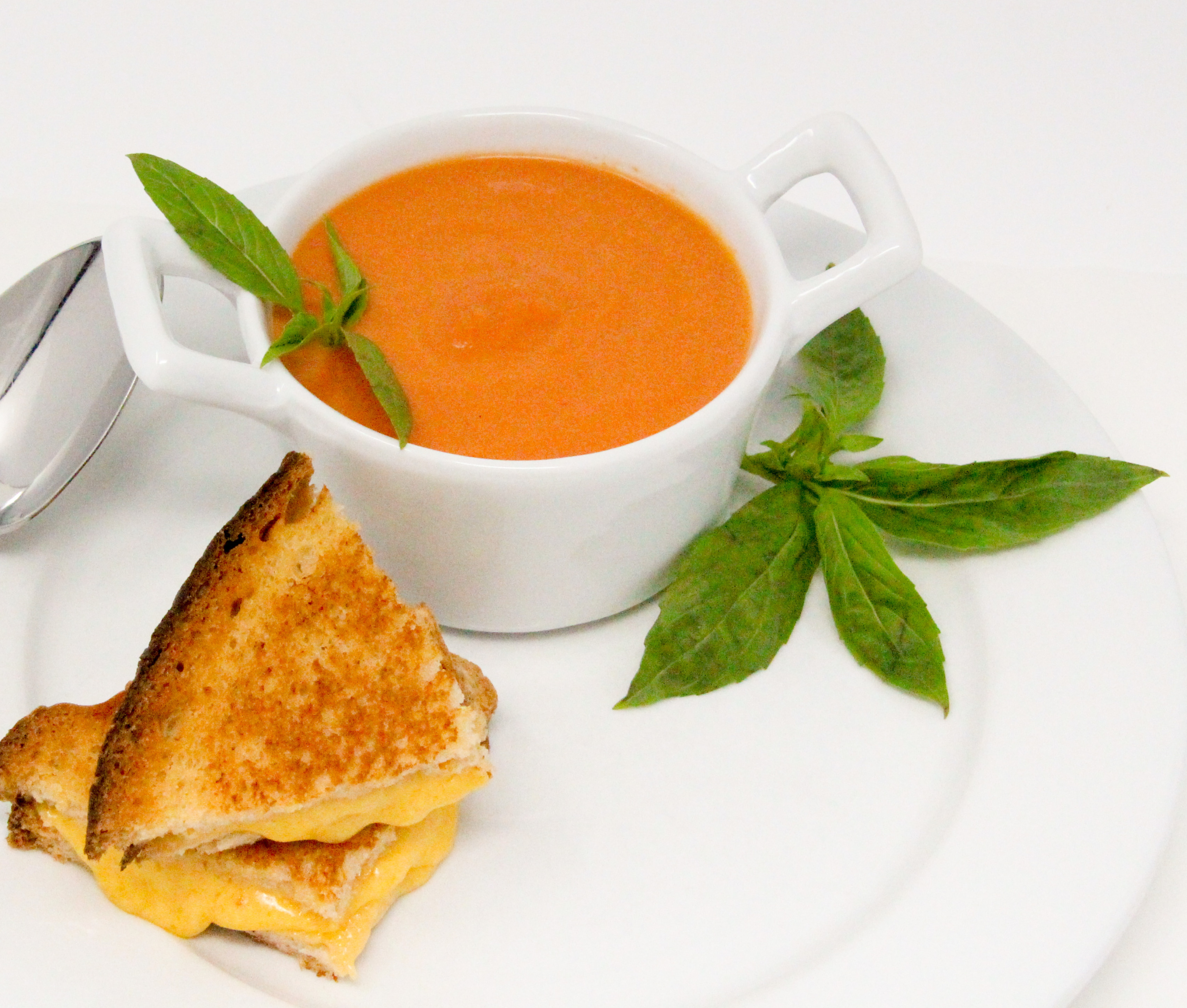 Grant's Tomato Soup uses canned San Marzano tomatoes, plus the addition of other fresh ingredients and sherry which elevates the flavor to yum. With a bit a cream, the added richness complements the tang of cheese in a grilled cheese sandwich. Recipe shared with permission granted by Linda Reilly, author of CHEDDER LATE THAN DEAD. 