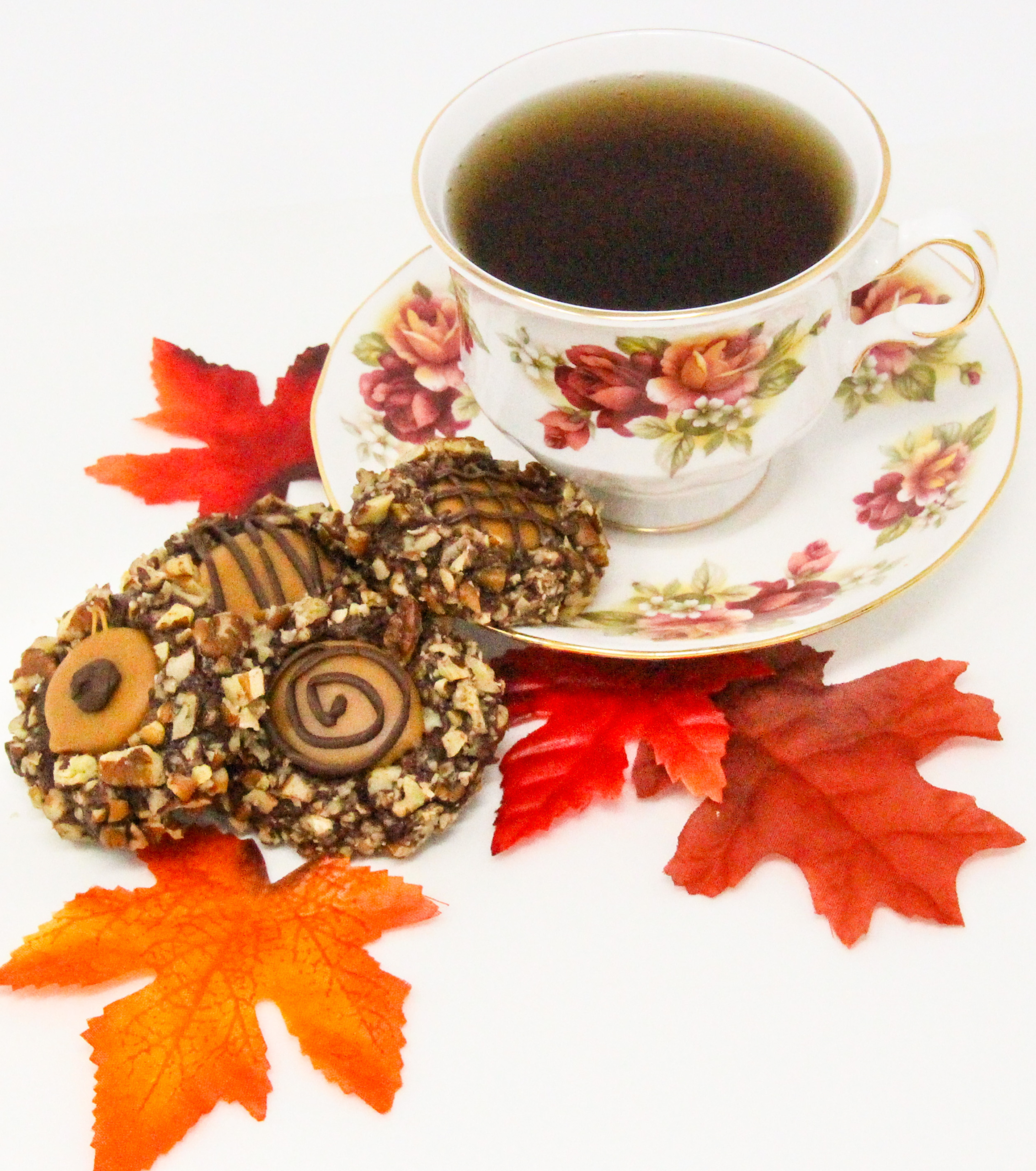 Turtle Cookies start with a rich chocolate cookie base, then rolled in chopped pecans, and filled with creamy caramel. This delightful treat is decadent enough to make Santa linger hearthside. Recipe shared with permission granted by Maddie Day, author of CHRISTMAS SCARF MURDER. 