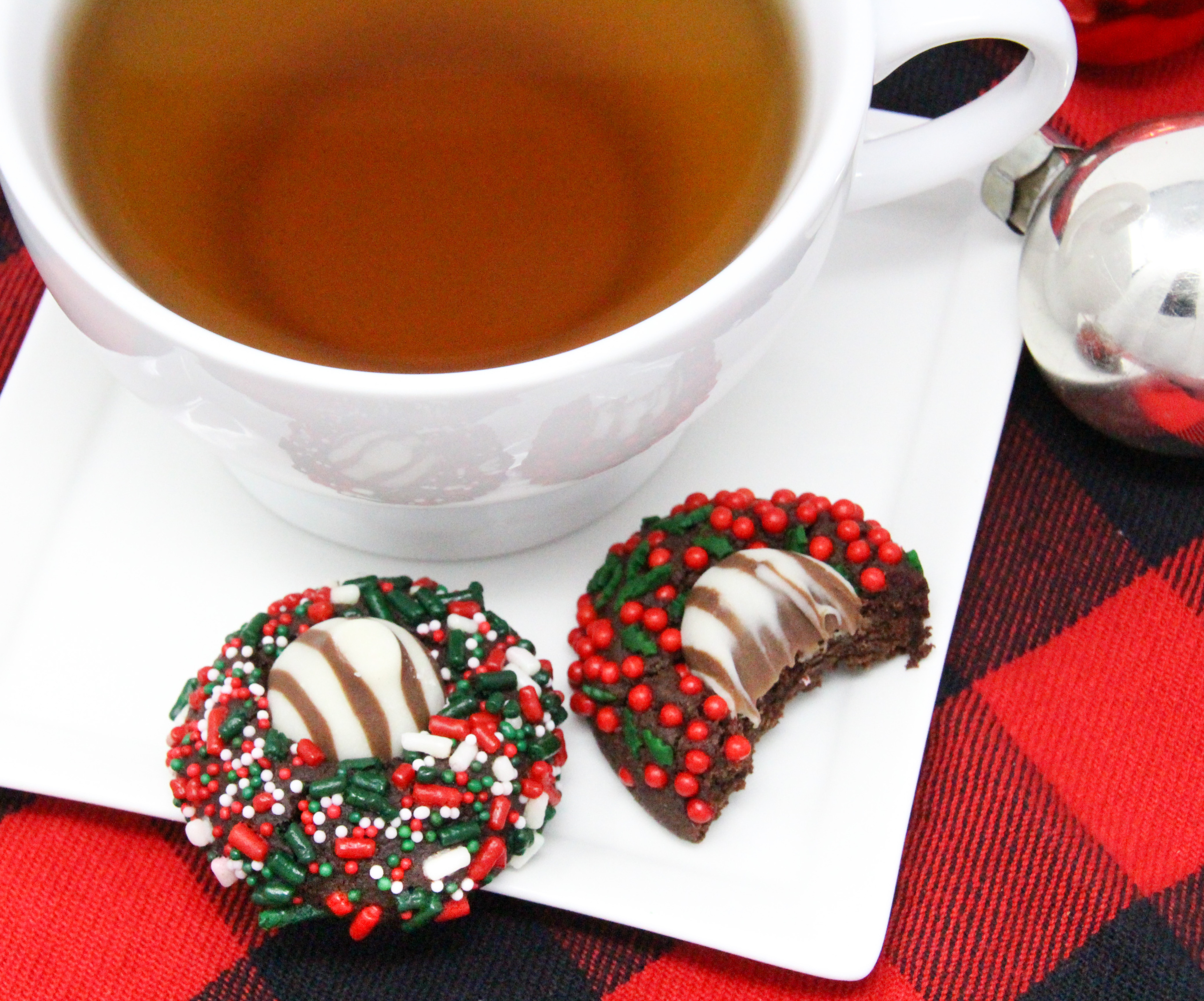 Christmas Hugs & Kisses Cookies have a chocolate base with a hint of peppermint. Rolled in colorful holiday sprinkles before baking then topped with a Hershey’s Hug or Kiss for an extra bite of chocolate will have Santa linger hearthside to finish a plate of these festive cookies! Recipe created by Cinnamon & Sugar for Deborah Garner, author of JOY AT MOONGLOW. 