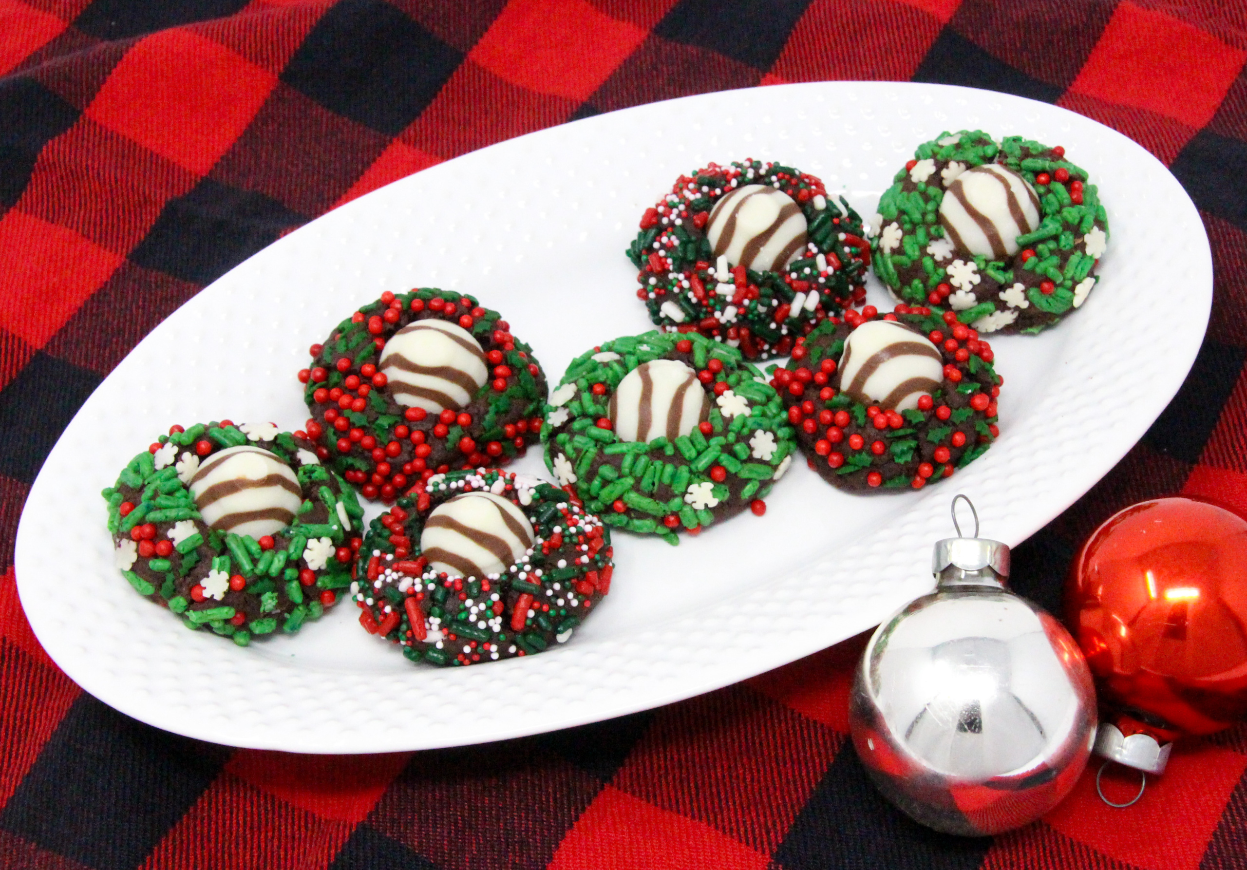 Christmas Hugs & Kisses Cookies have a chocolate base with a hint of peppermint. Rolled in colorful holiday sprinkles before baking then topped with a Hershey’s Hug or Kiss for an extra bite of chocolate will have Santa linger hearthside to finish a plate of these festive cookies! Recipe created by Cinnamon & Sugar for Deborah Garner, author of JOY AT MOONGLOW. 