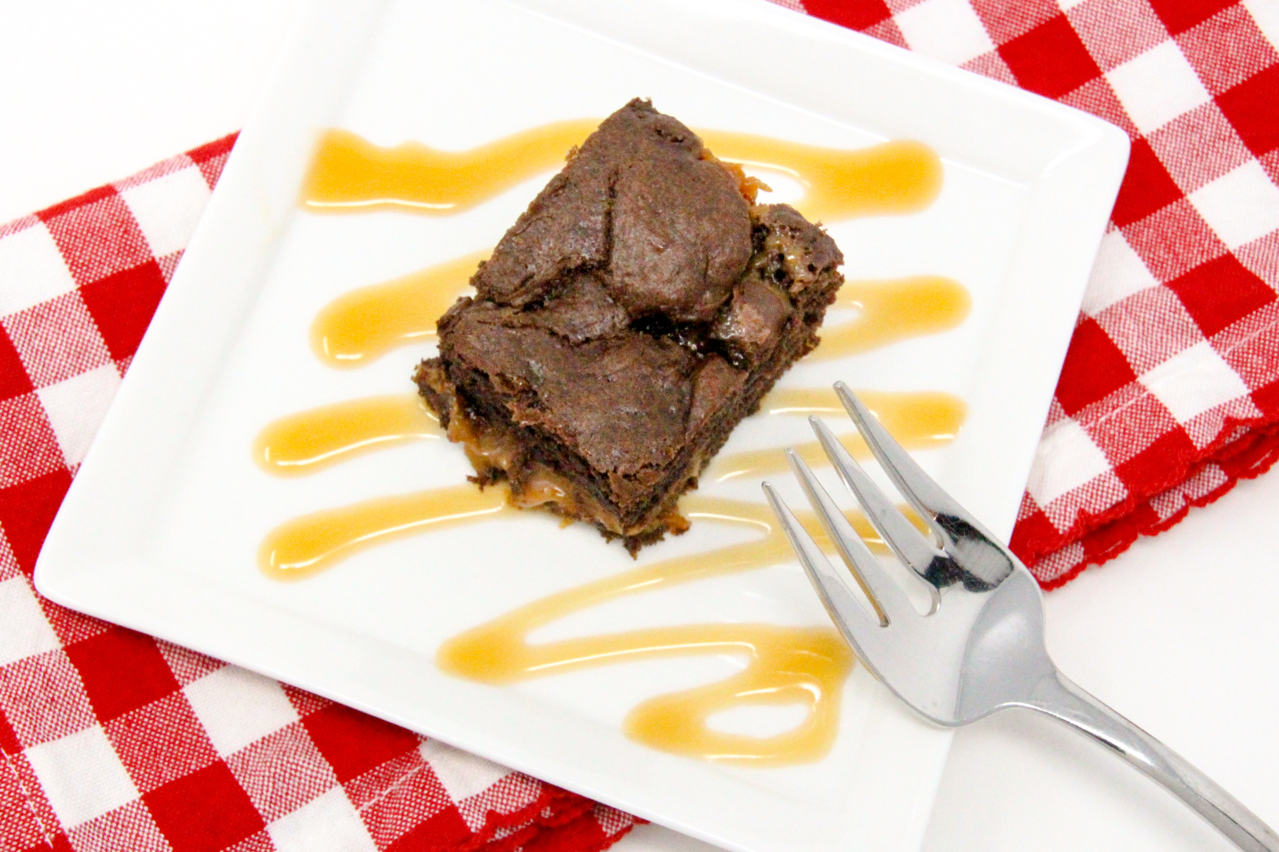 Double-Chocolate Caramel Brownies are the perfect combination of rich chocolaty goodness combined with creamy caramel that elevates these to pure deliciousness. And starting with a boxed cake mix, these are a cinch to make. Recipe shared with permission granted by Daryl Wood Gerber, author of A FLICKER OF A DOUBT. 