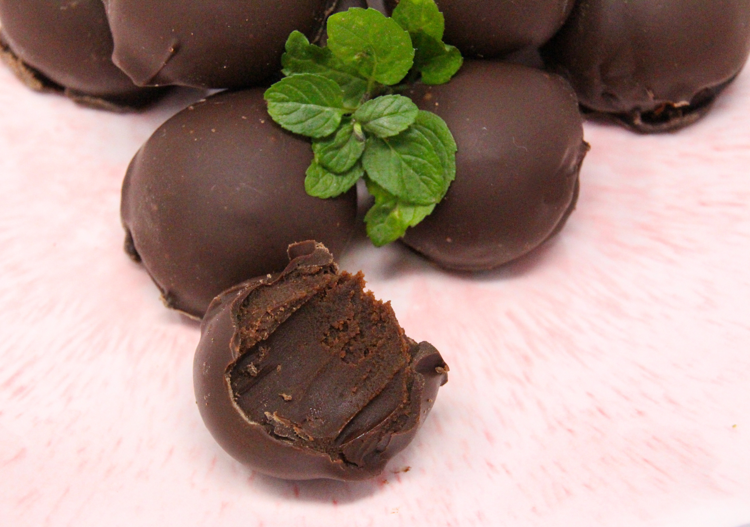 Mint Melty Truffles are delicately mint-flavored, melt-in-your-mouth, candies. With filling encased in a generous portion of dark chocolate, these treats make for a perfect gift or a special way to spoil yourself! Recipe shared with permission granted by Sarah Fox, author of Six Sweets Under. 