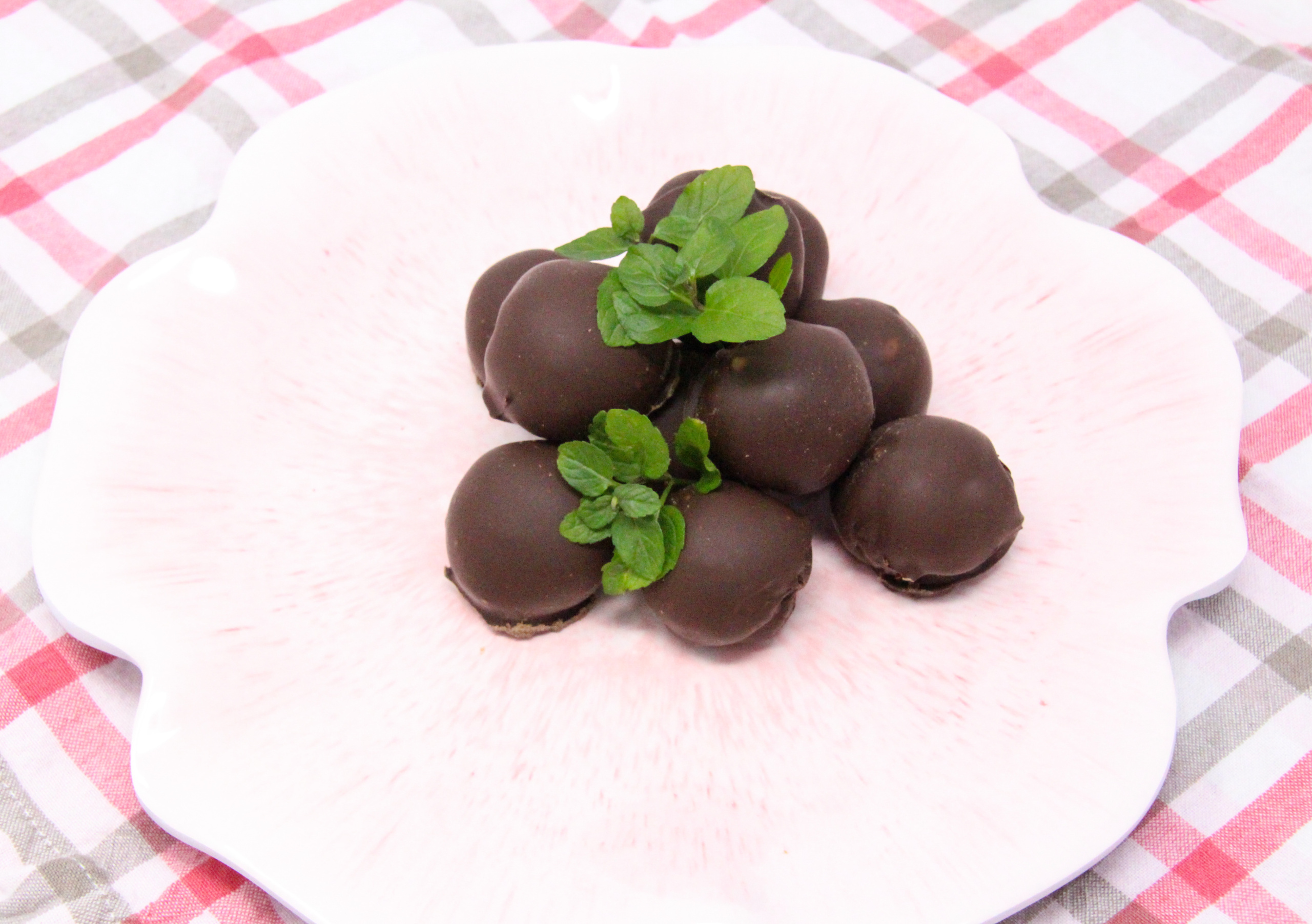 Mint Melty Truffles are delicately mint-flavored, melt-in-your-mouth, candies. With filling encased in a generous portion of dark chocolate, these treats make for a perfect gift or a special way to spoil yourself! Recipe shared with permission granted by Sarah Fox, author of Six Sweets Under. 