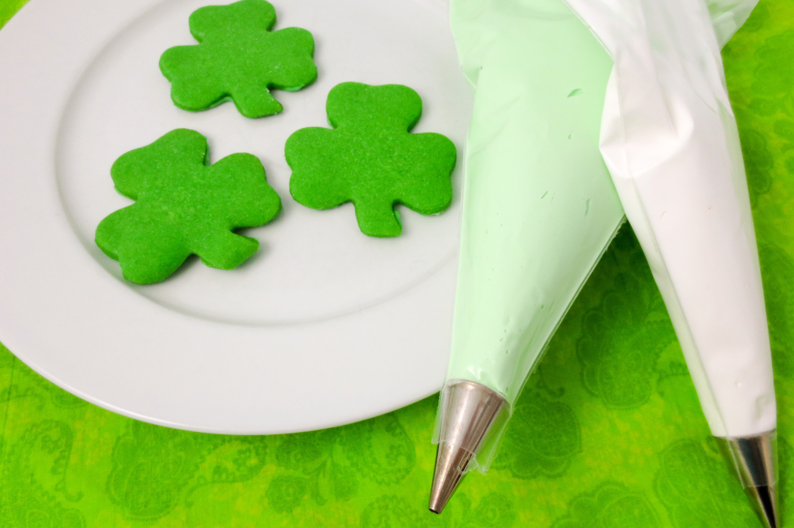 Shamrock cookies are mint-flavored sugar cookies decorated with royal icing (and/or sprinkles) in the quintessential St. Patrick’s Day shape. They are sure to bring a smile and good luck to everyone you share them with! Recipe developed by Cinnamon & Sugar for Deborah Garner, author of A FLAIR FOR SHAMROCKS. 